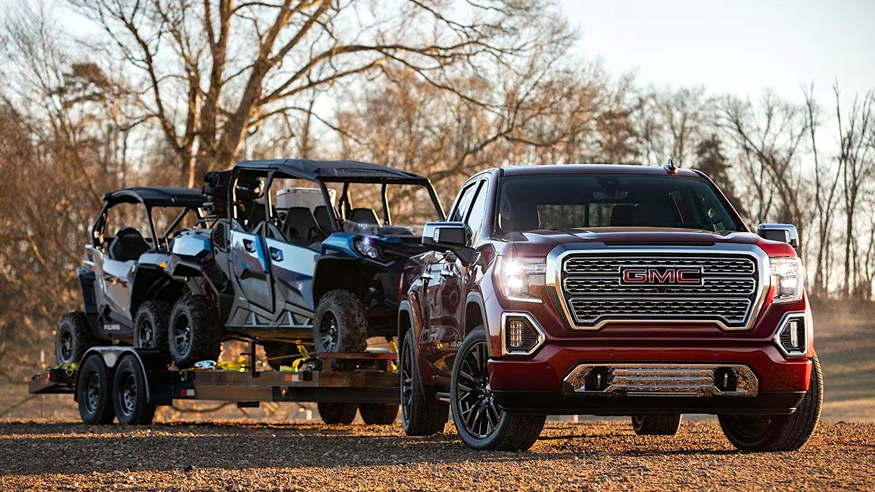 Image of GMC 1500 2019-2021 towing two ATVs.