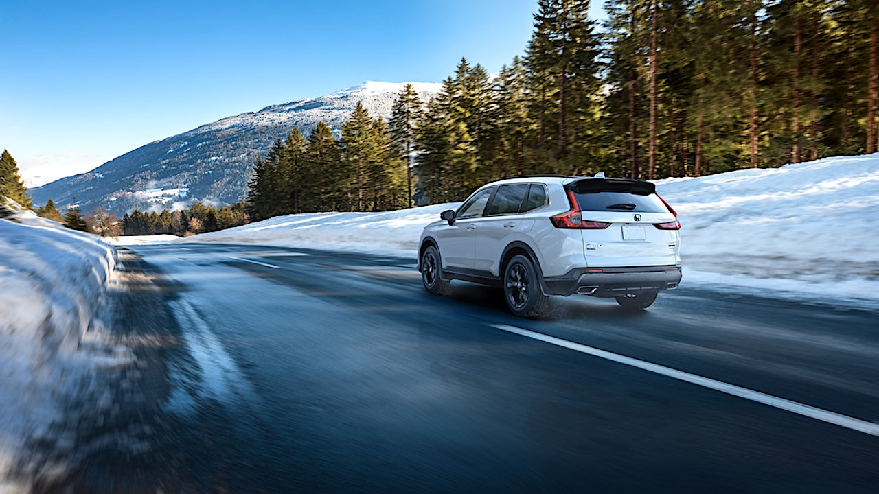 Honda CR-V 2023-2026 on a winter road.