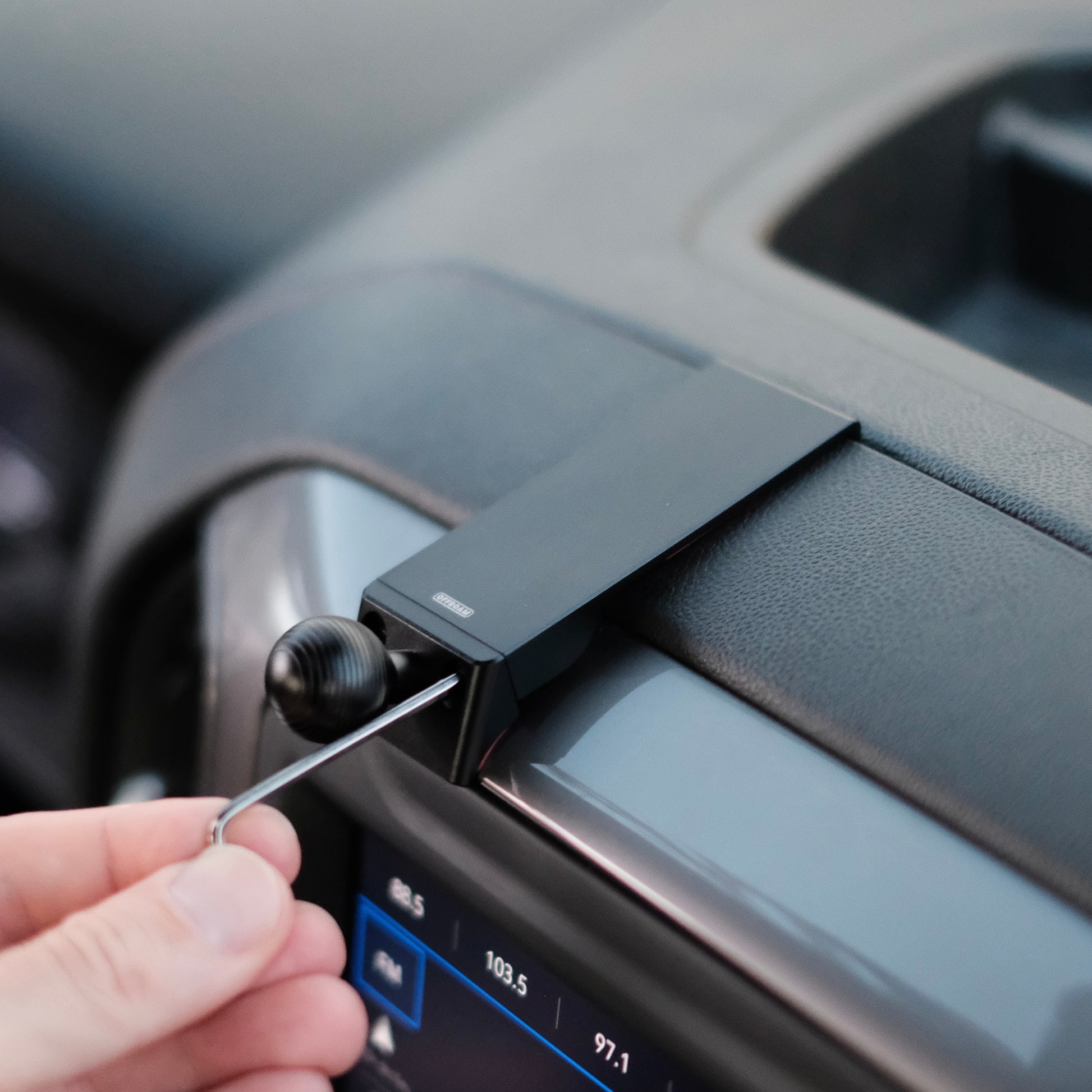 Image of Offroam Mounting Base installed securely in Chevrolet Silverado 2019-2024 | Silverado HD 2020-2024 and GMC Sierra 1500 2019-2021 | Sierra HD 2020-2023 with 7-in.|8-in. display. This premium all metal phone mounting base installs easily without drilling or glue. Perfect placement without blocking screens, driver view, or air flow.