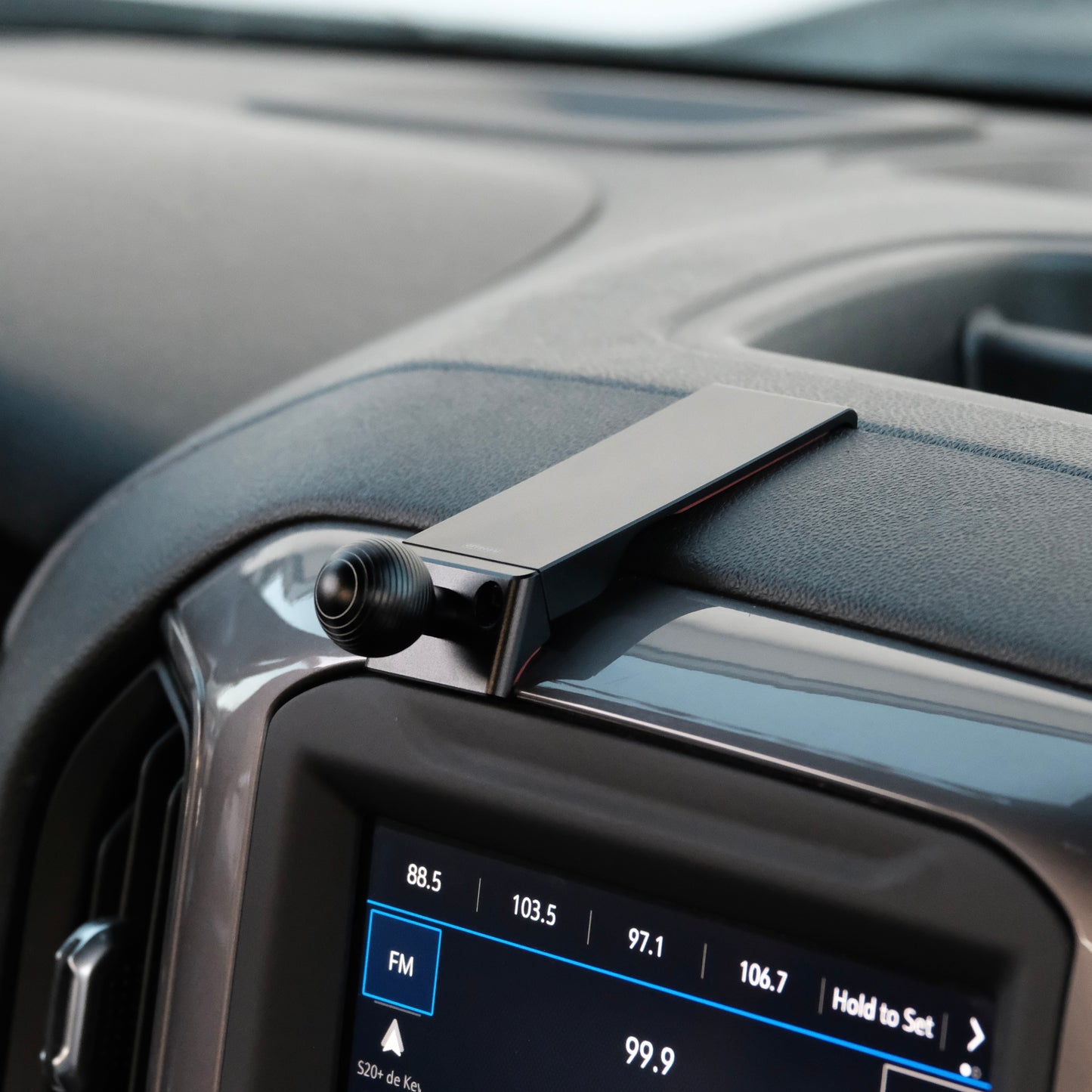 Image of Offroam Mounting Base installed securely in Chevrolet Silverado 2019-2024 | Silverado HD 2020-2024 and GMC Sierra 1500 2019-2021 | Sierra HD 2020-2023 with 7-in.|8-in. display. This premium all metal phone mounting base installs easily without drilling or glue. Perfect placement without blocking screens, driver view, or air flow.