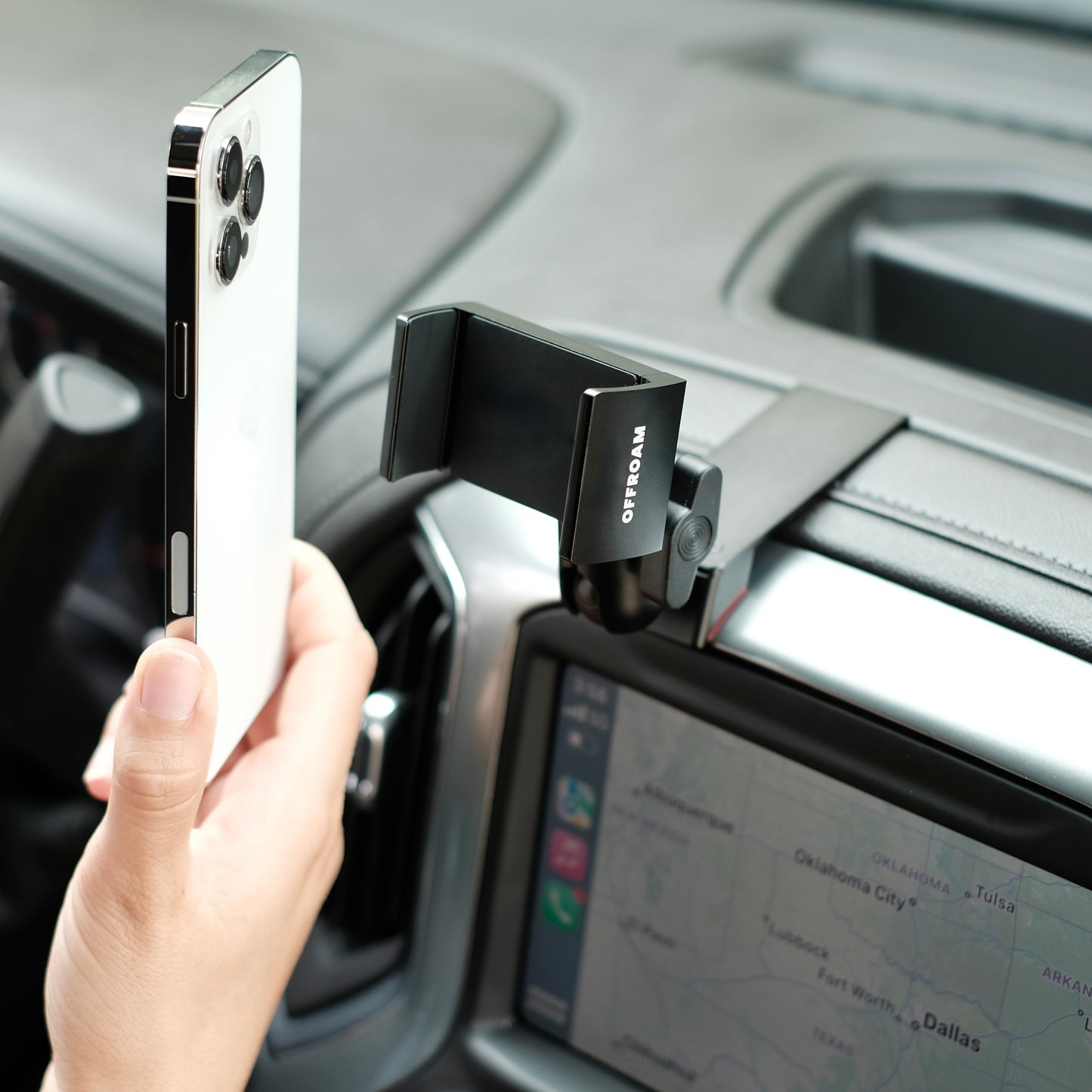 Image of Offroam Phone Mount installed securely in Chevrolet Silverado 2019-2024 | Silverado HD 2020-2024 and GMC Sierra 1500 2019-2021 | Sierra HD 2020-2023 with 7-in.|8-in. display. This premium phone mount installs easily without drilling or glue. Spring loaded Universal holder for use with any phone. Perfect placement without blocking screens, driver view, or air flow. Fully adjustable positioning.