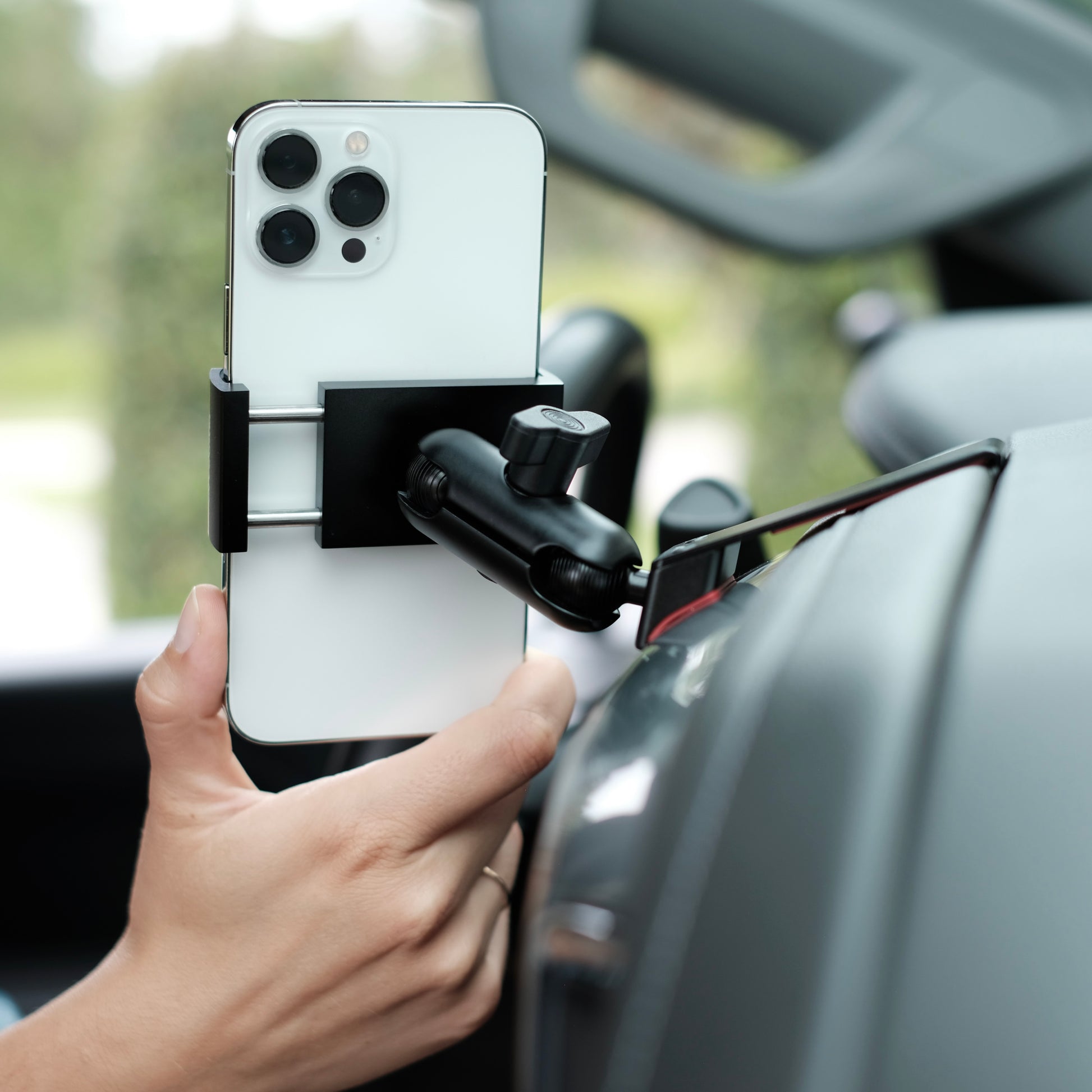 Image of Offroam Phone Mount installed securely in Chevrolet Silverado 2019-2024 | Silverado HD 2020-2024 and GMC Sierra 1500 2019-2021 | Sierra HD 2020-2023 with 7-in.|8-in. display. This premium phone mount installs easily without drilling or glue. Spring loaded Universal holder for use with any phone. Perfect placement without blocking screens, driver view, or air flow. Fully adjustable positioning.