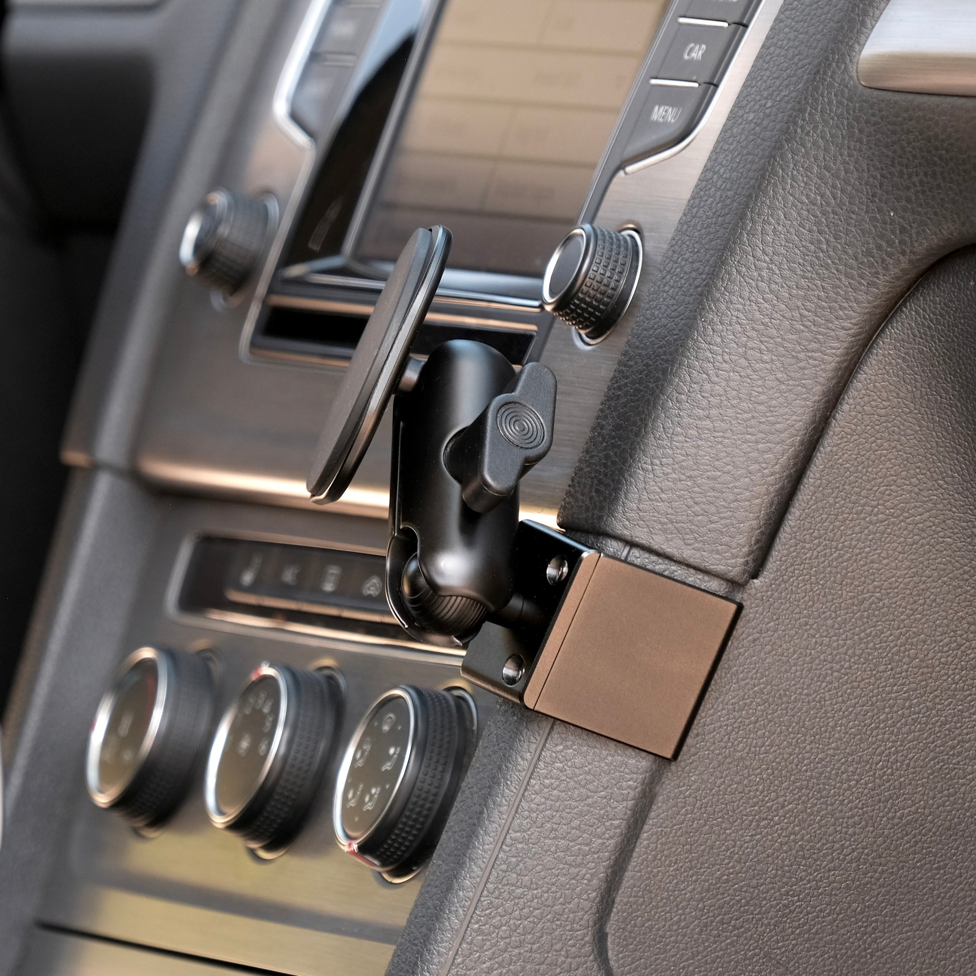 Image of Offroam MagSafe-compatible Phone Mount installed securely in Volkswagen Golf 2015-2021. This premium phone mount installs easily without drilling or glue. High force magnets hold phone on any trail, road, or track. Perfect placement without blocking screens, driver view, or air flow. Fully adjustable positioning.