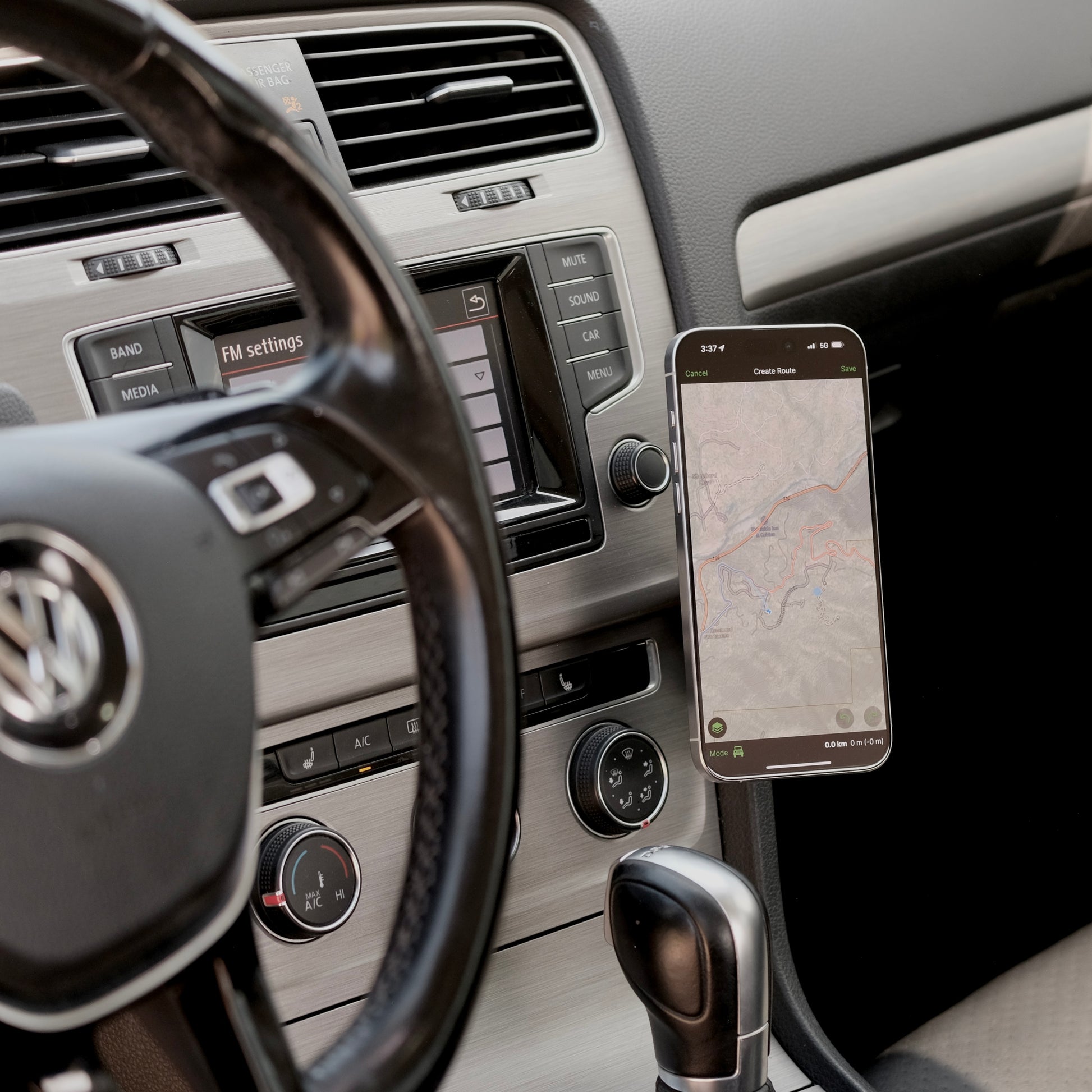 Image of Offroam MagSafe-compatible Phone Mount installed securely in Volkswagen Golf 2015-2021. This premium phone mount installs easily without drilling or glue. High force magnets hold phone on any trail, road, or track. Perfect placement without blocking screens, driver view, or air flow. Fully adjustable positioning.