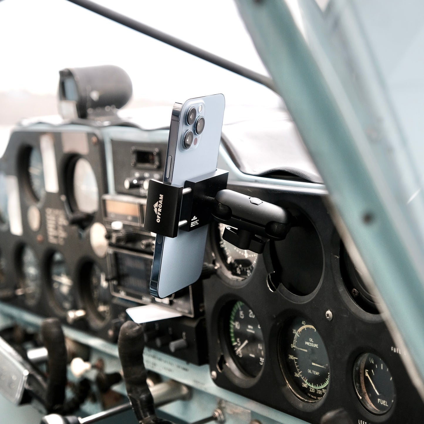 Image of Offroam Phone Mount for all General Aviation (GA) aircraft with inoperable instrument availability. This premium phone mount installs easily without drilling or glue. Spring loaded Universal holder for use with any phone. Perfect placement without blocking glass, analog gauges, or cockpit view. Fully adjustable positioning.