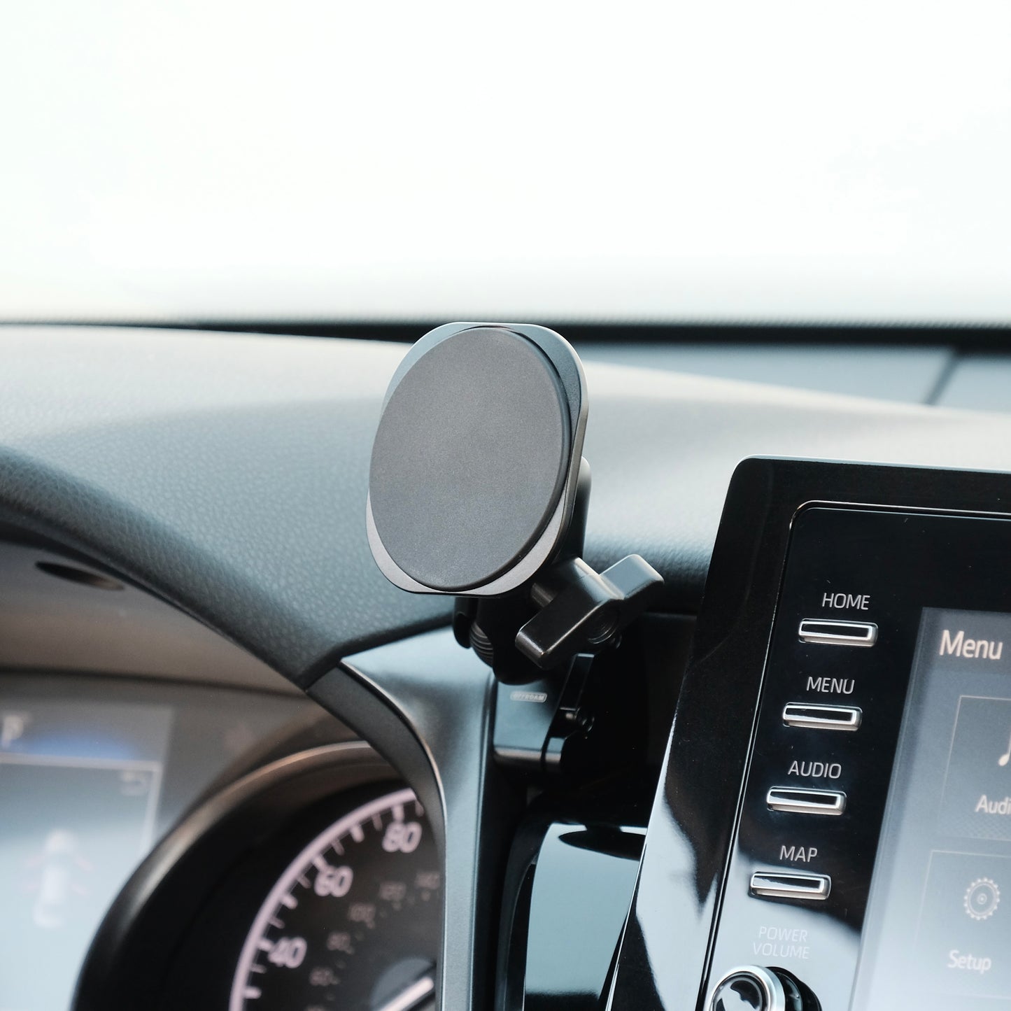 Image of Offroam MagSafe-compatible Phone Mount installed securely in Toyota Camry 2021-2024. This premium phone mount installs easily without drilling or glue. High force magnets hold phone on any trail, road, or track. Perfect placement without blocking screens, driver view, or air flow. Fully adjustable positioning.