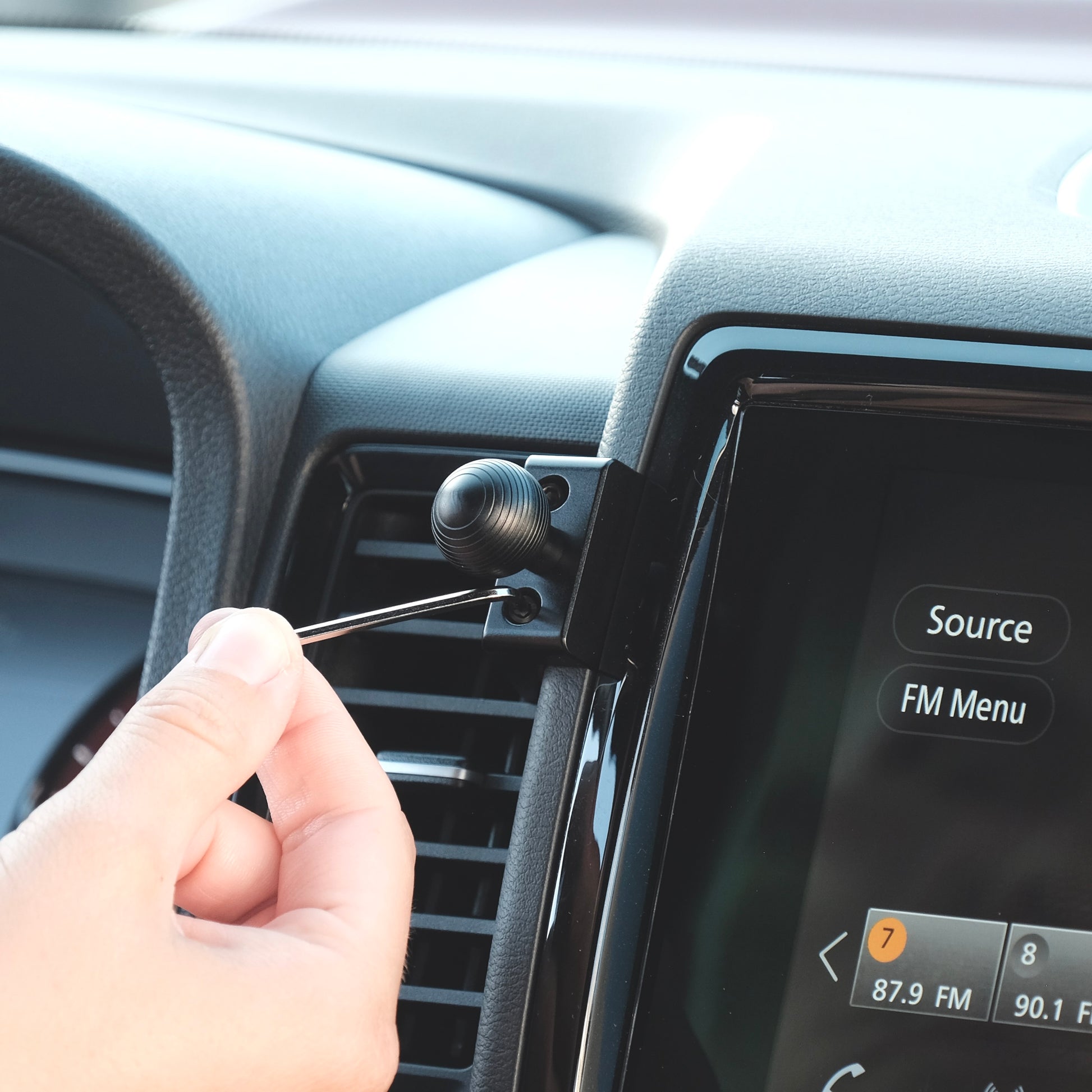 Image of Offroam Mounting Base installed securely in Nissan Frontier 2022-2024. This premium all metal phone mounting base installs easily without drilling or glue. Perfect placement without blocking screens, driver view, or air flow.