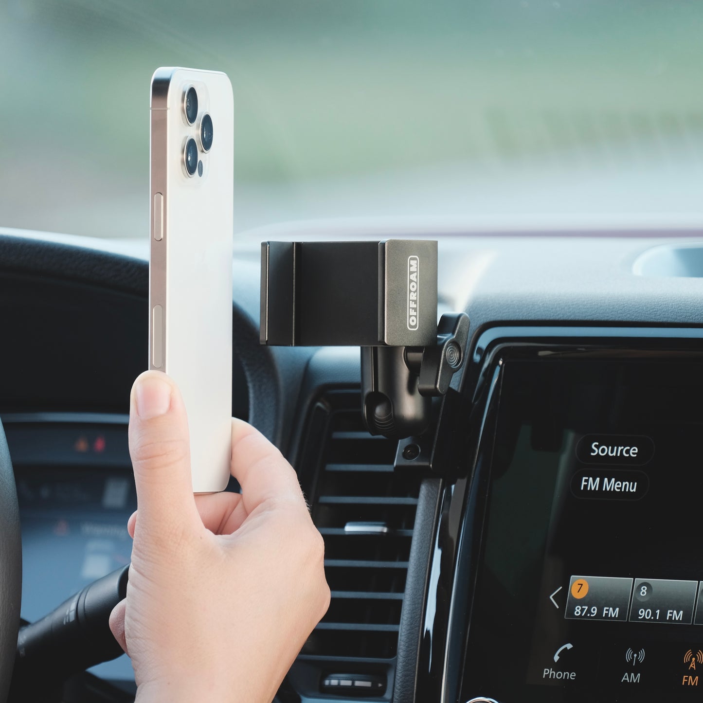 Image of Offroam Phone Mount installed securely in Nissan Frontier 2022-2024. This premium phone mount installs easily without drilling or glue. Spring loaded Universal holder for use with any phone. Perfect placement without blocking screens, driver view, or air flow. Fully adjustable positioning.