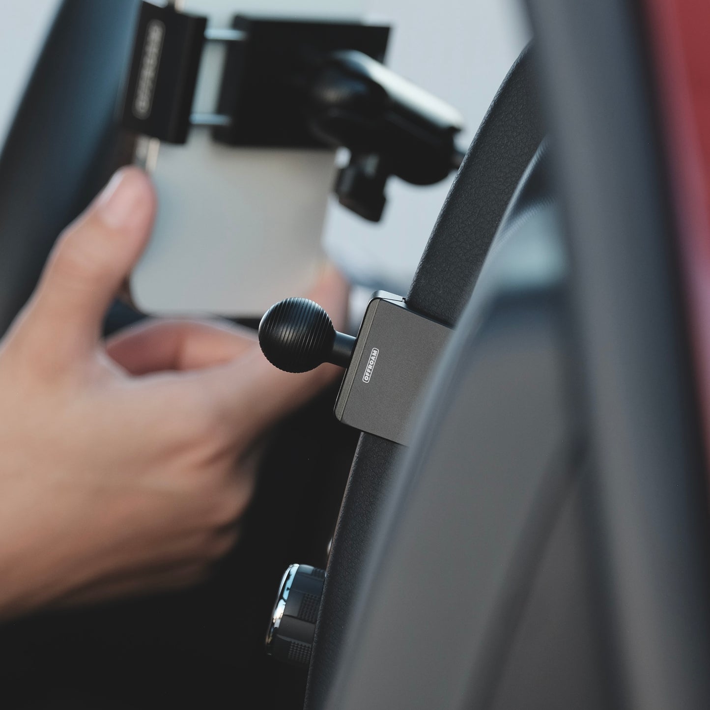 Image of Offroam Mounting Base installed securely in Nissan Frontier 2022-2024. This premium all metal phone mounting base installs easily without drilling or glue. Perfect placement without blocking screens, driver view, or air flow.