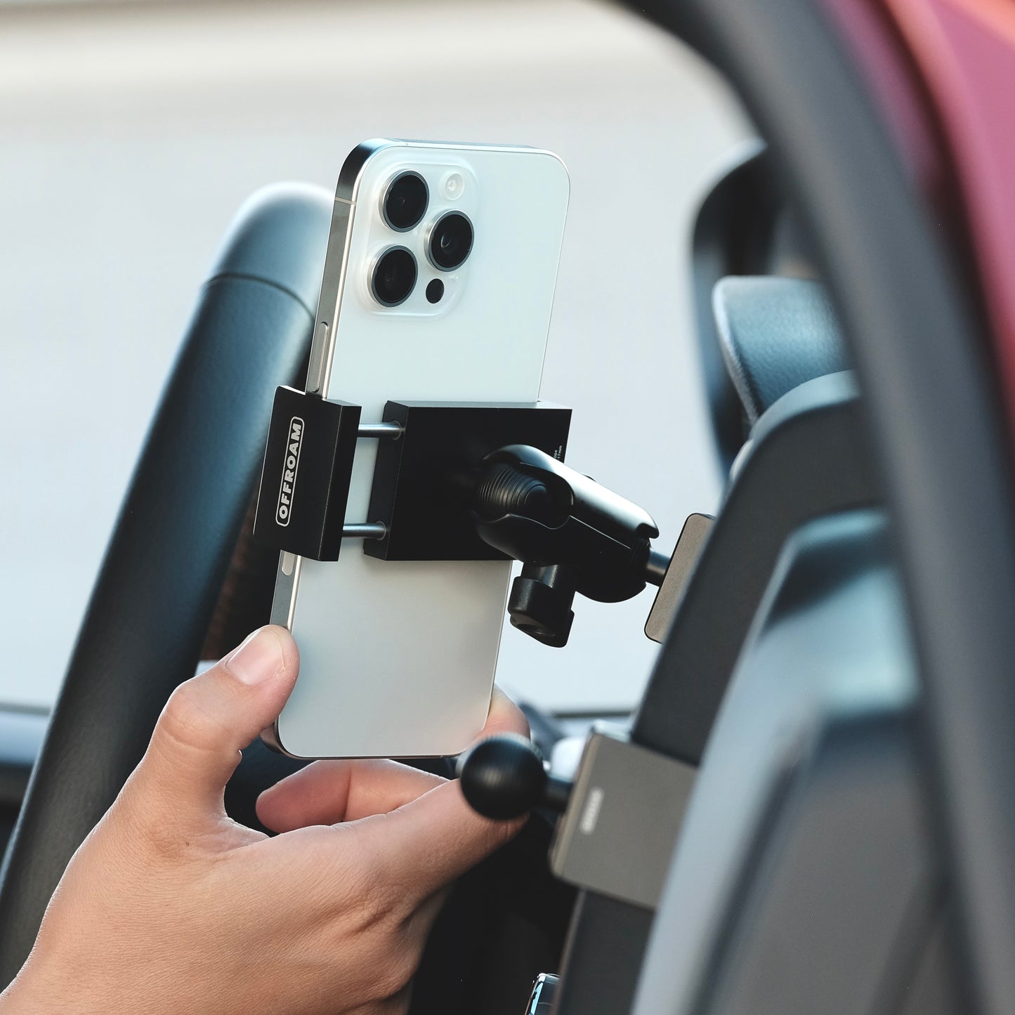 Image of Offroam Phone Mount installed securely in Nissan Frontier 2022-2024. This premium phone mount installs easily without drilling or glue. Spring loaded Universal holder for use with any phone. Perfect placement without blocking screens, driver view, or air flow. Fully adjustable positioning.