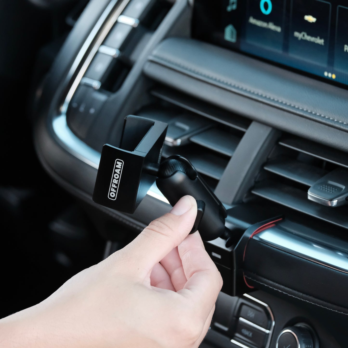 Image of Offroam Phone Mount installed securely in Chevrolet Suburban | Tahoe & GMC Yukon | Yukon XL 2021-2024. This premium phone mount installs easily without drilling or glue. Spring loaded Universal holder for use with any phone. Perfect placement without blocking screens, driver view, or air flow. Fully adjustable positioning.