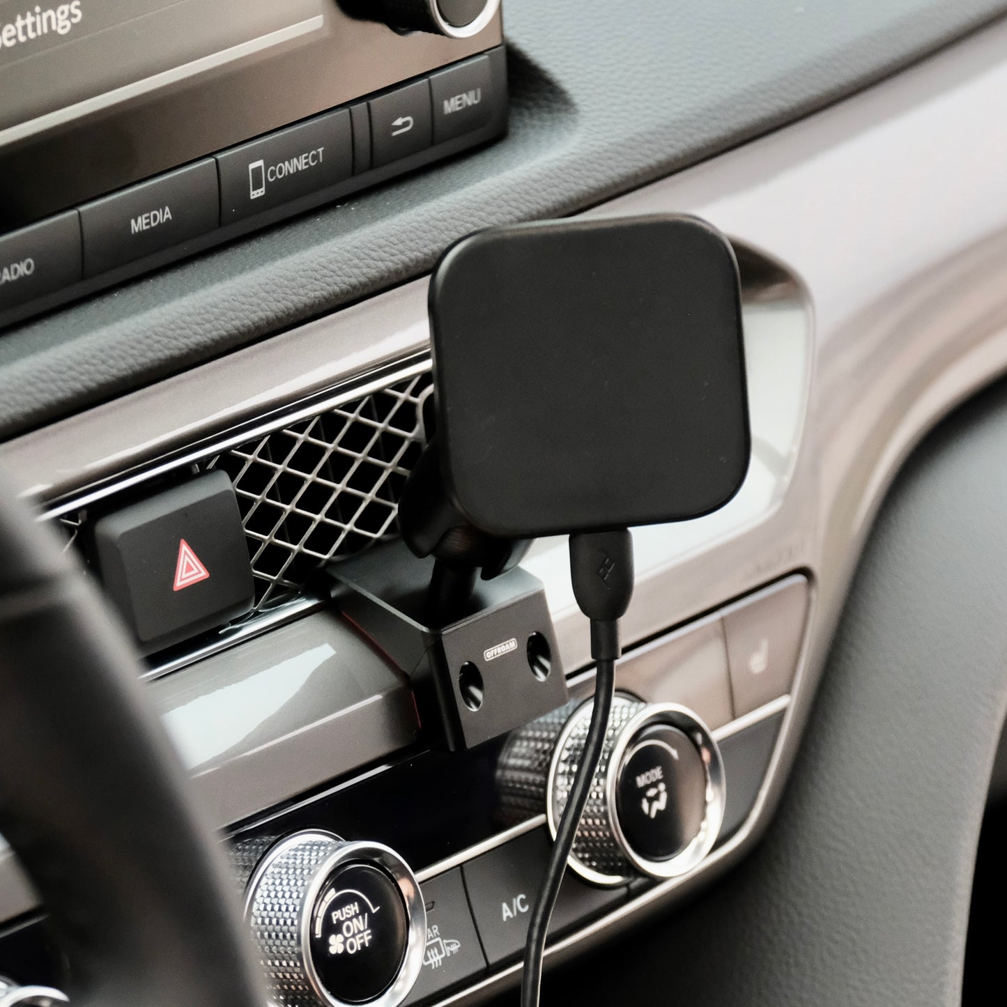 Image of Offroam MagSafe-compatible Phone Mount installed securely in Acura Integra 2023-2026. This premium phone mount installs easily without drilling or glue. High force magnets hold phone on any trail, road, or track. Perfect placement without blocking screens, driver view, or air flow. Fully adjustable positioning.