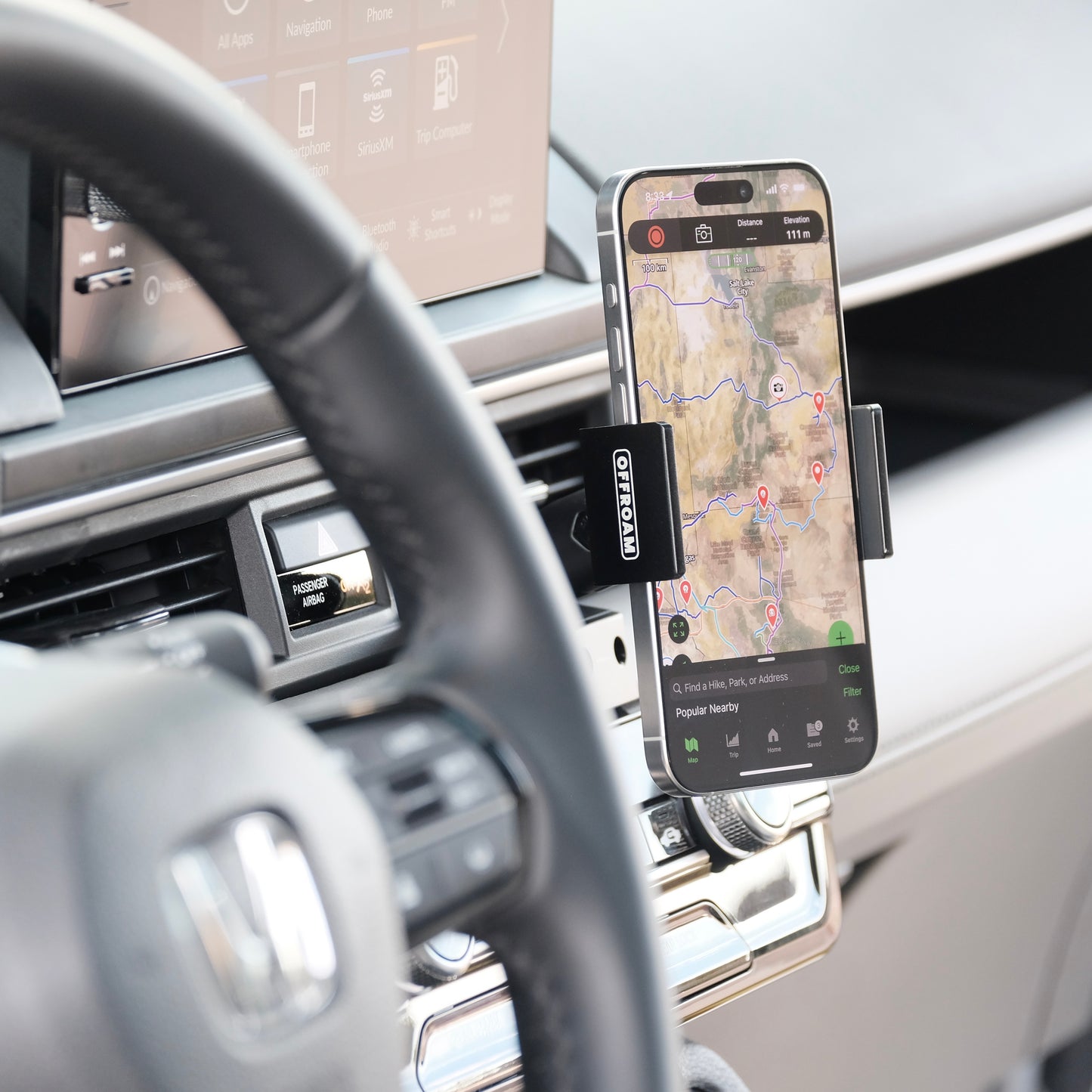 Image of Offroam Phone Mount installed securely in Honda Pilot 2023-2025 | Passport 2026. This premium phone mount installs easily without drilling or glue. Spring loaded Universal holder for use with any phone. Perfect placement without blocking screens, driver view, or air flow. Fully adjustable positioning.
