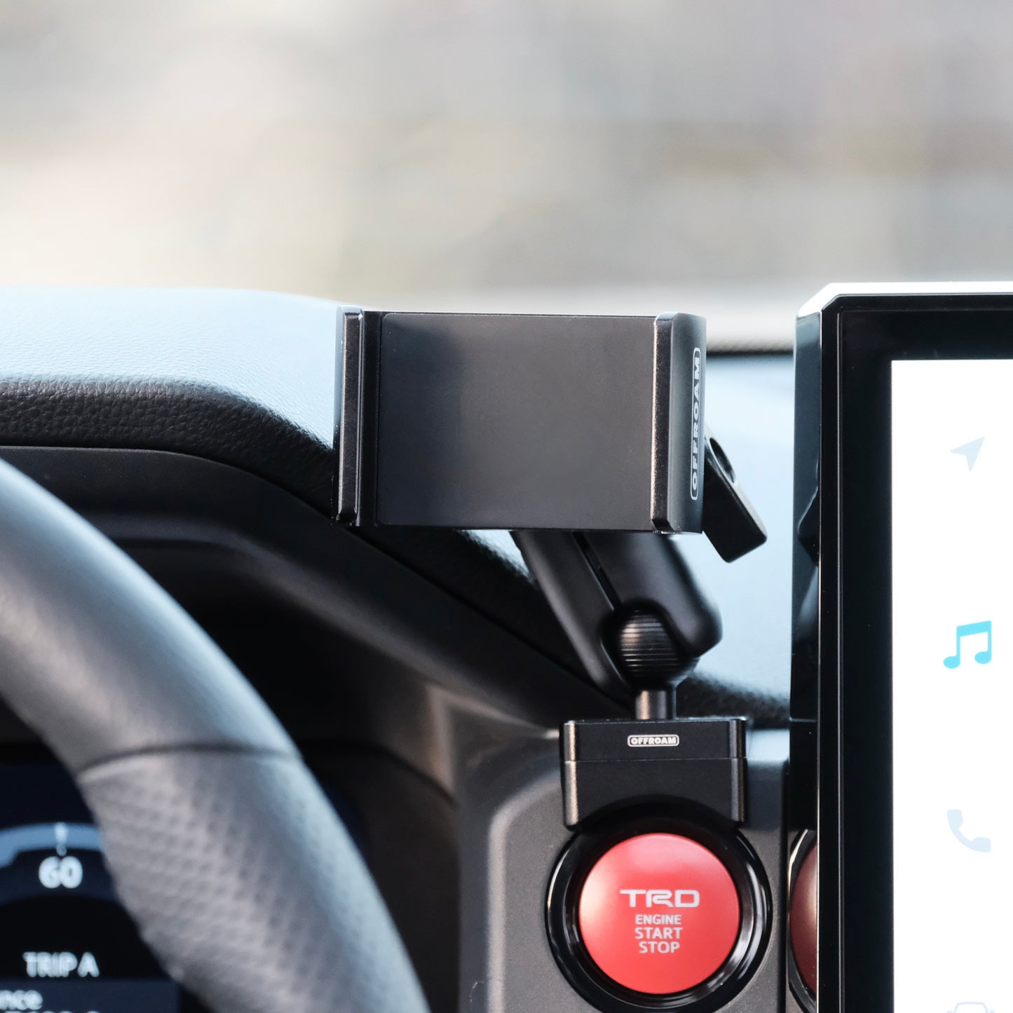 Image of Offroam Phone Mount installed securely in Toyota Tacoma 2024-2025 | 4Runner 2025. This premium phone mount installs easily without drilling or glue. Spring loaded Universal holder for use with any phone. Perfect placement without blocking screens, driver view, or air flow. Fully adjustable positioning.