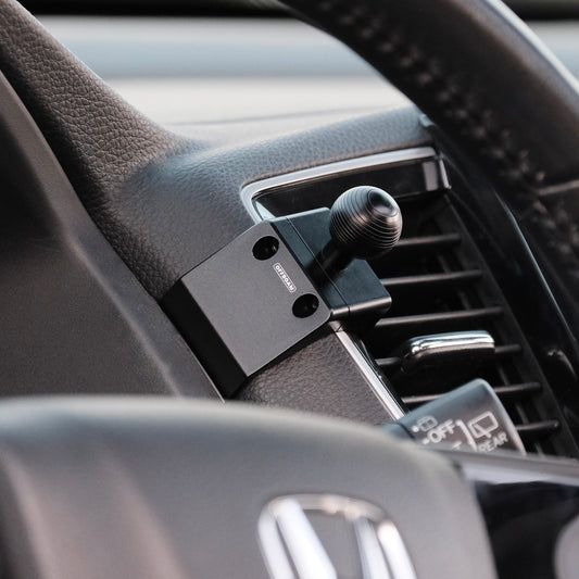 Image of Offroam Mounting Base installed securely in Honda Ridgeline 2016-2025 | Passport 2019-2025 | Pilot 2016-2022. This premium all metal phone mounting base installs easily without drilling or glue. Perfect placement without blocking screens, driver view, or air flow.