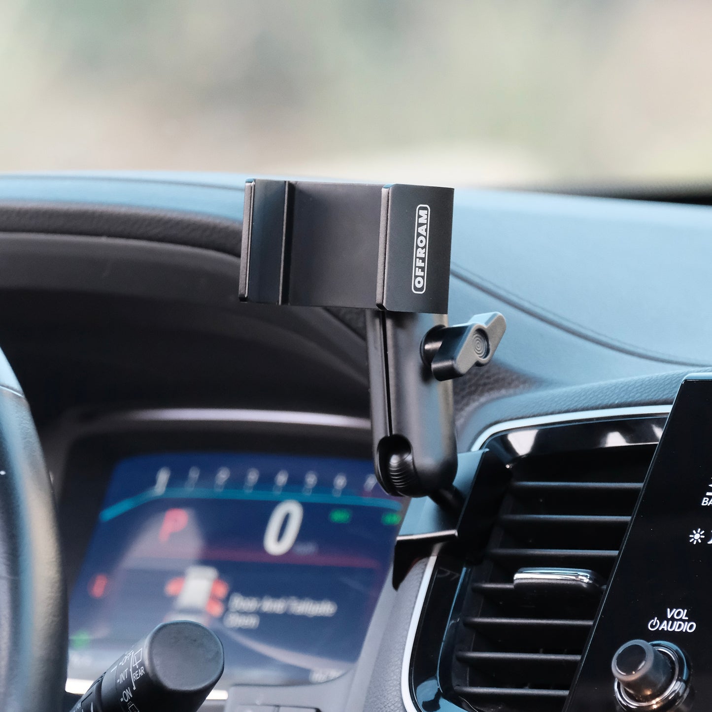 Image of Offroam Phone Mount installed securely in Honda Ridgeline 2016-2025 | Passport 2019-2025 | Pilot 2016-2022. This premium phone mount installs easily without drilling or glue. Spring loaded Universal holder for use with any phone. Perfect placement without blocking screens, driver view, or air flow. Fully adjustable positioning.