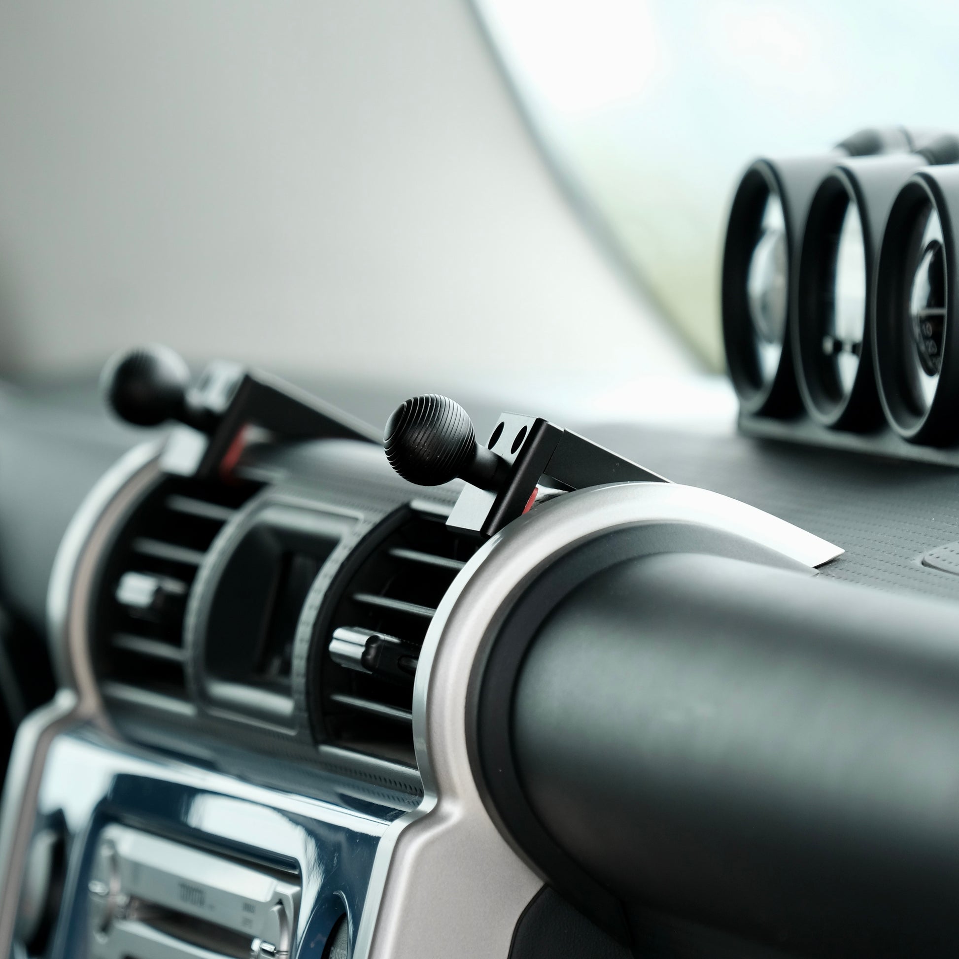 Image of Offroam Mounting Bases installed securely in Toyota FJ Cruiser 2007-2014. This premium all metal phone mounting base installs easily without drilling or glue. Perfect placement without blocking screens, driver view, or air flow.