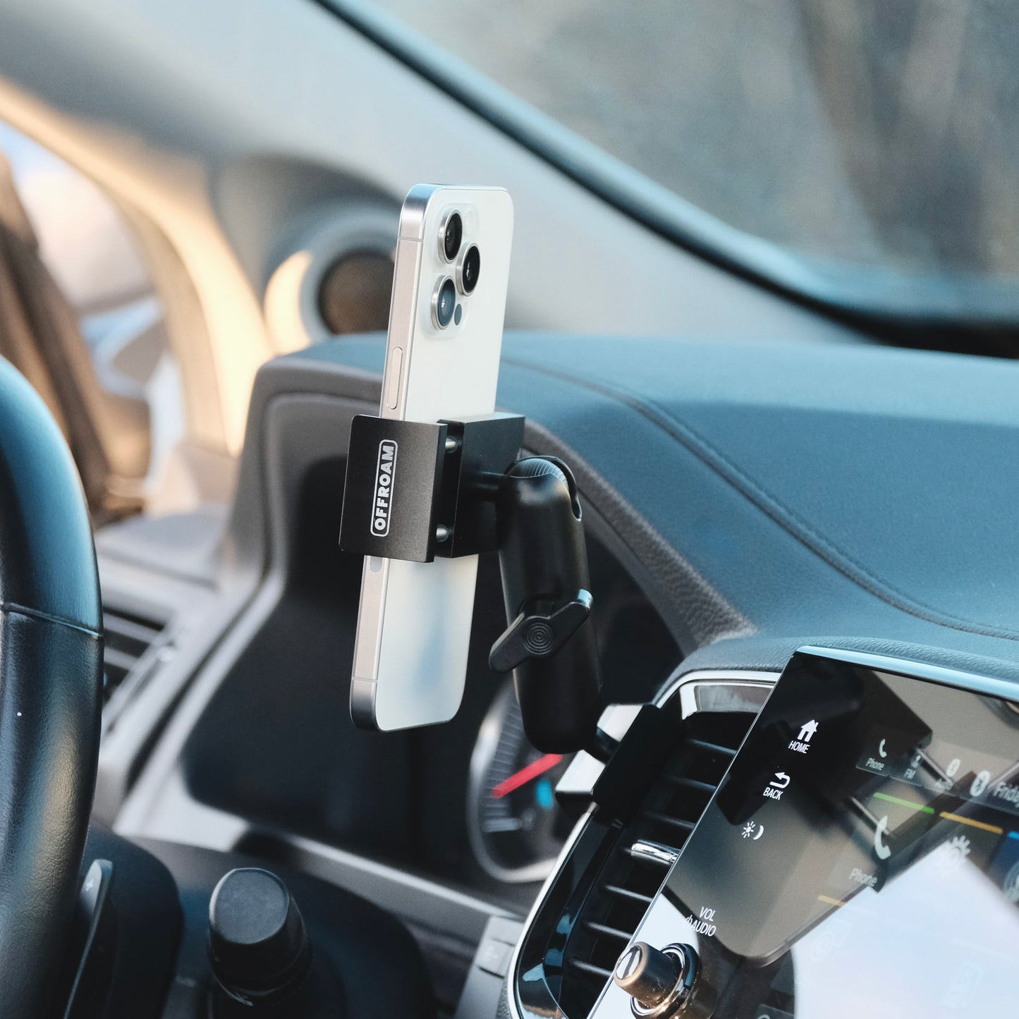 Image of Offroam Phone Mount installed securely in Honda Ridgeline 2016-2025 | Passport 2019-2025 | Pilot 2016-2022. This premium phone mount installs easily without drilling or glue. Spring loaded Universal holder for use with any phone. Perfect placement without blocking screens, driver view, or air flow. Fully adjustable positioning.