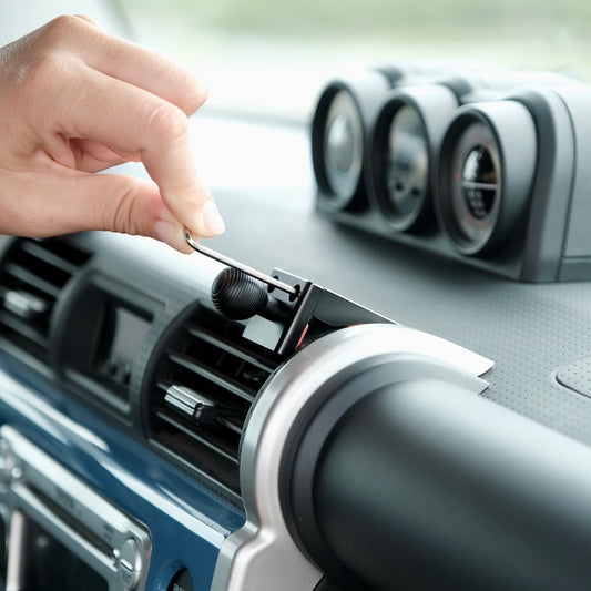Image of Offroam Mounting Base installed securely in Toyota FJ Cruiser 2007-2014. This premium all metal phone mounting base installs easily without drilling or glue. Perfect placement without blocking screens, driver view, or air flow.