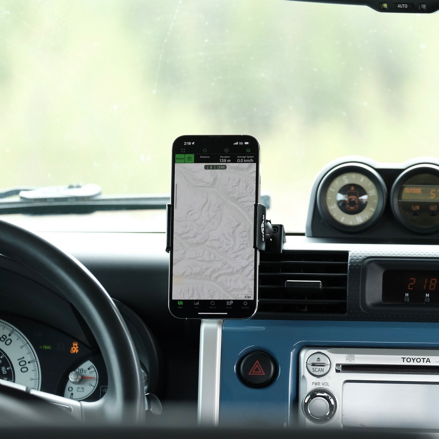 Image of Offroam Phone Mount installed securely in Toyota FJ Cruiser 2007-2014. This premium phone mount installs easily without drilling or glue. Spring loaded Universal holder for use with any phone. Perfect placement without blocking screens, driver view, or air flow. Fully adjustable positioning.