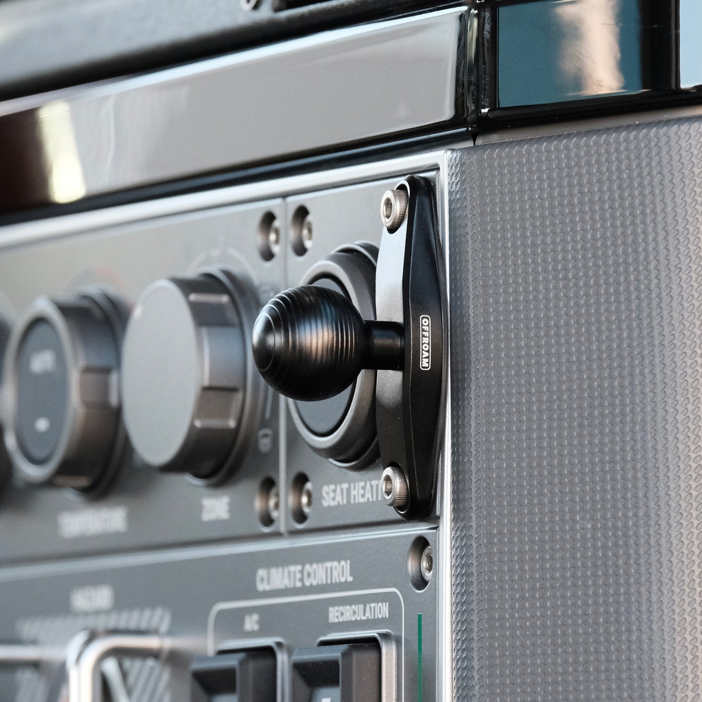 Image of Offroam Mounting Base installed securely in INEOS Grenadier 2022-2025. This premium all metal phone mounting base installs easily without drilling or glue. Perfect placement without blocking screens, driver view, or air flow.