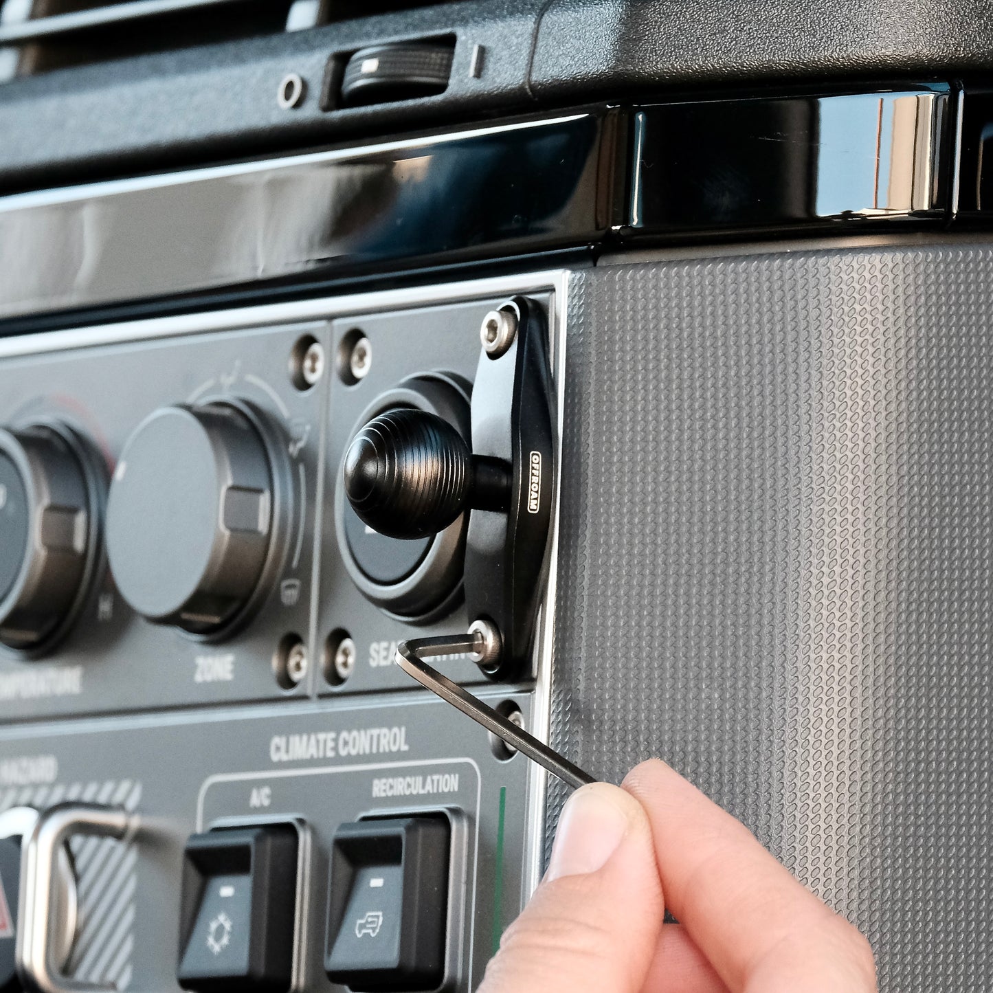 Image of Offroam Mounting Base installed securely in INEOS Grenadier 2022-2025. This premium all metal phone mounting base installs easily without drilling or glue. Perfect placement without blocking screens, driver view, or air flow.