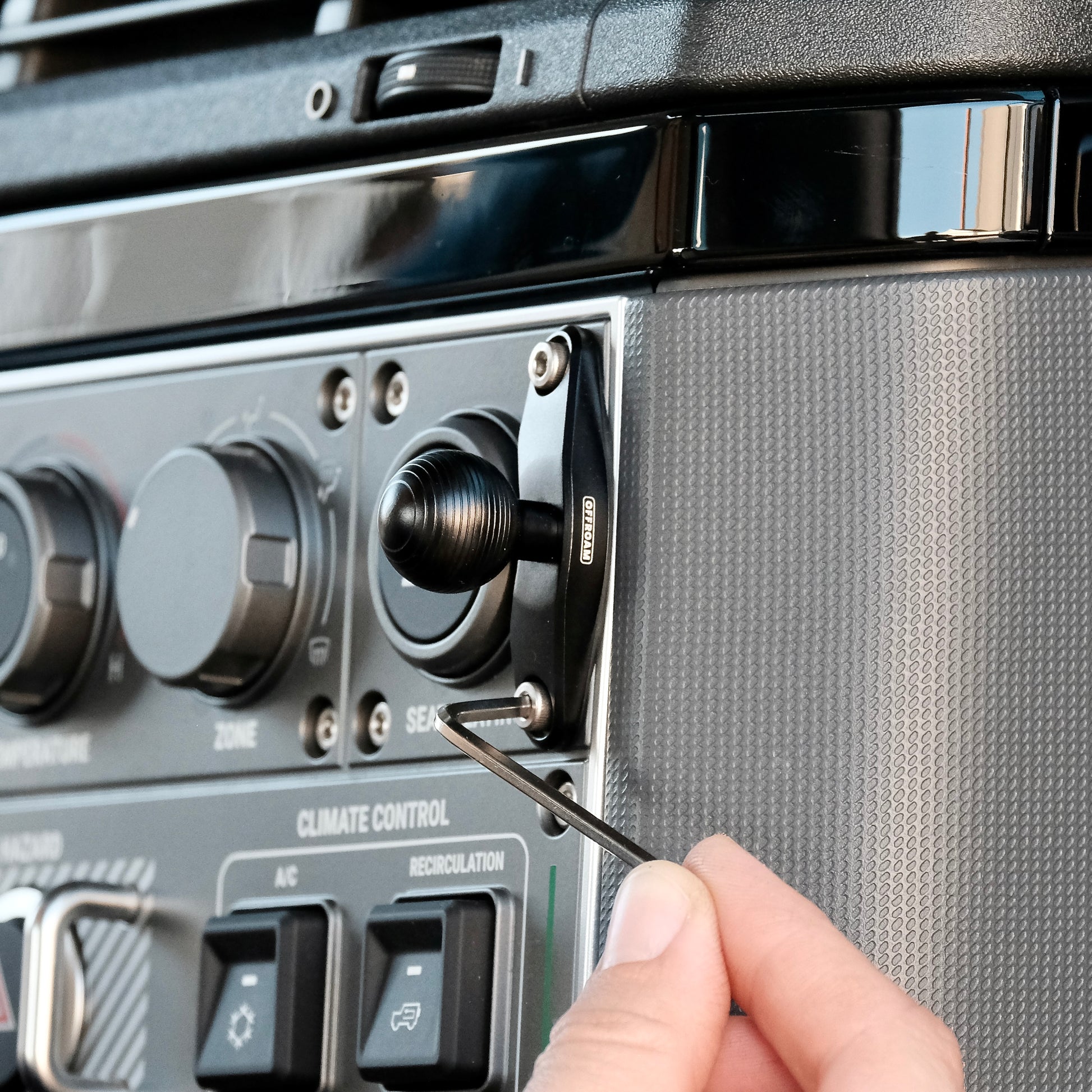 Image of Offroam Mounting Base installed securely in INEOS Grenadier 2022-2025. This premium all metal phone mounting base installs easily without drilling or glue. Perfect placement without blocking screens, driver view, or air flow.