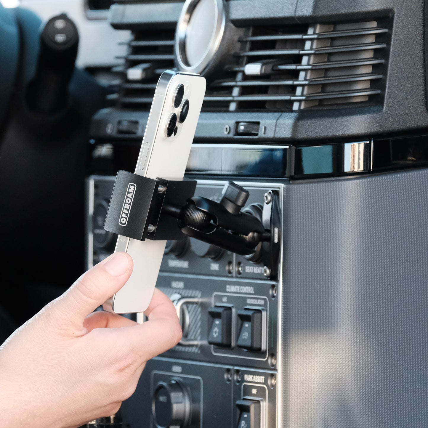 Image of Offroam Phone Mount installed securely in INEOS Grenadier 2022-2025. This premium phone mount installs easily without drilling or glue. Spring loaded Universal holder for use with any phone. Perfect placement without blocking screens, driver view, or air flow. Fully adjustable positioning.