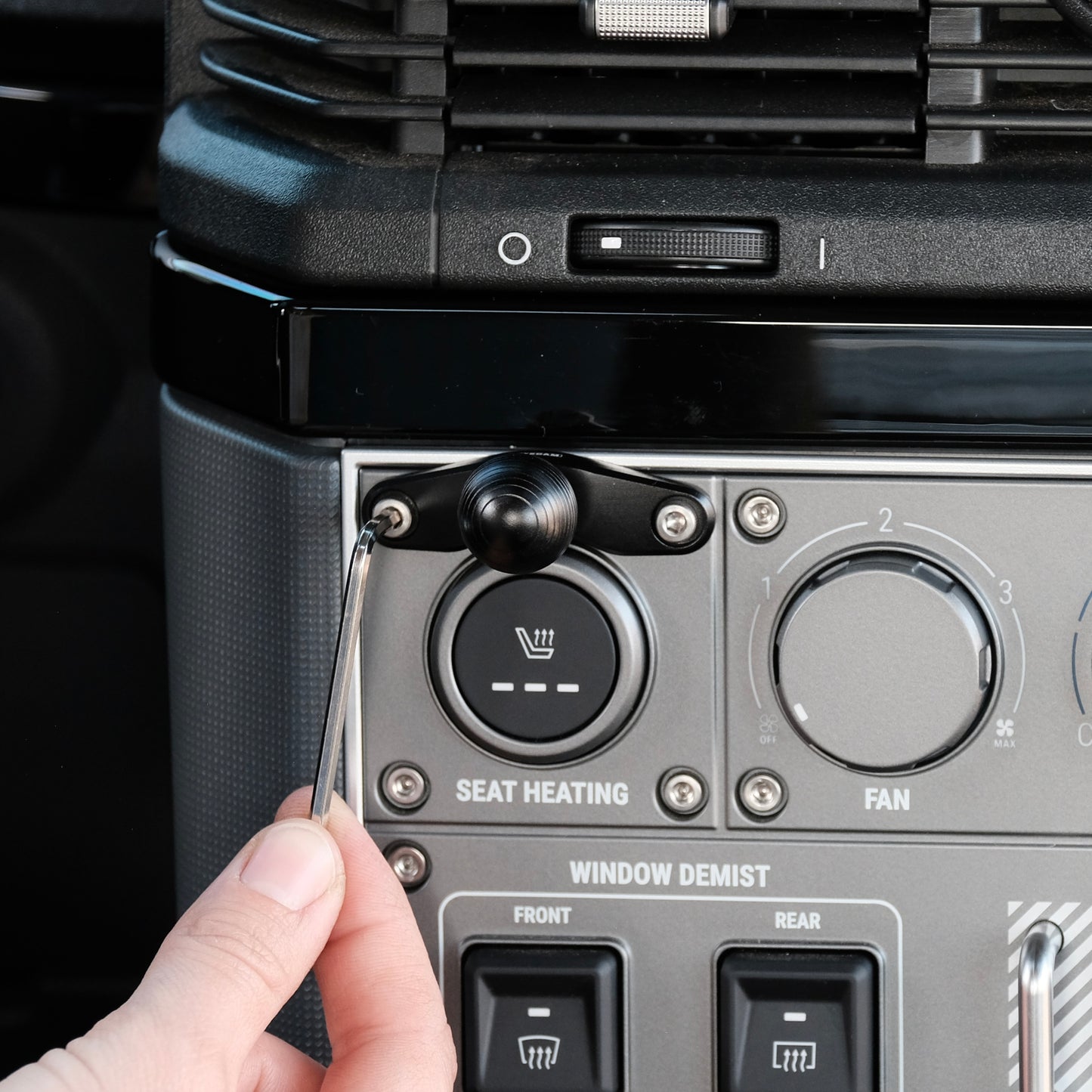 Image of Offroam Mounting Base installed securely in INEOS Grenadier 2022-2025. This premium all metal phone mounting base installs easily without drilling or glue. Perfect placement without blocking screens, driver view, or air flow.