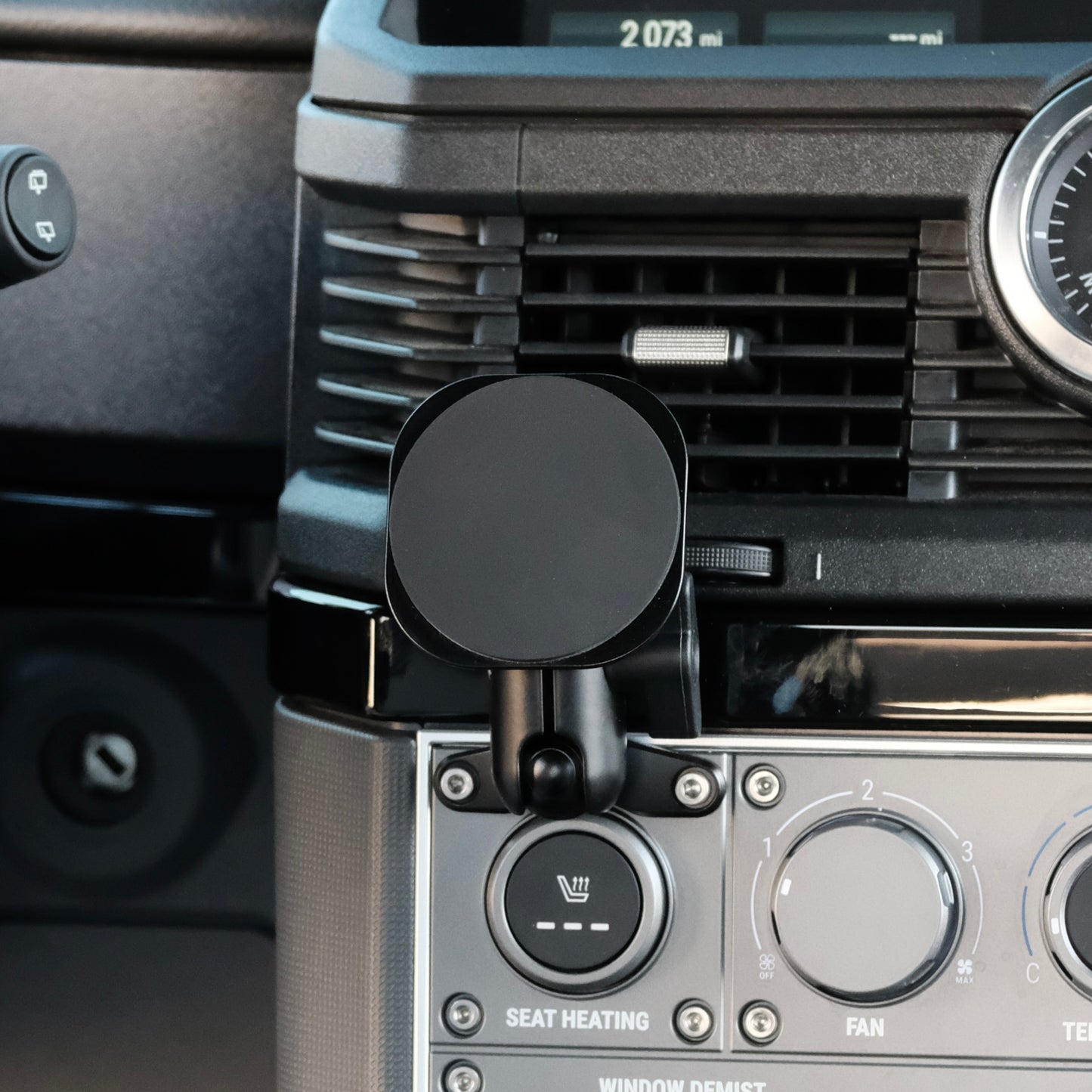 Image of Offroam MagSafe-compatible Phone Mount installed securely in INEOS Grenadier 2022-2025. This premium phone mount installs easily without drilling or glue. High force magnets hold phone on any trail, road, or track. Perfect placement without blocking screens, driver view, or air flow. Fully adjustable positioning.