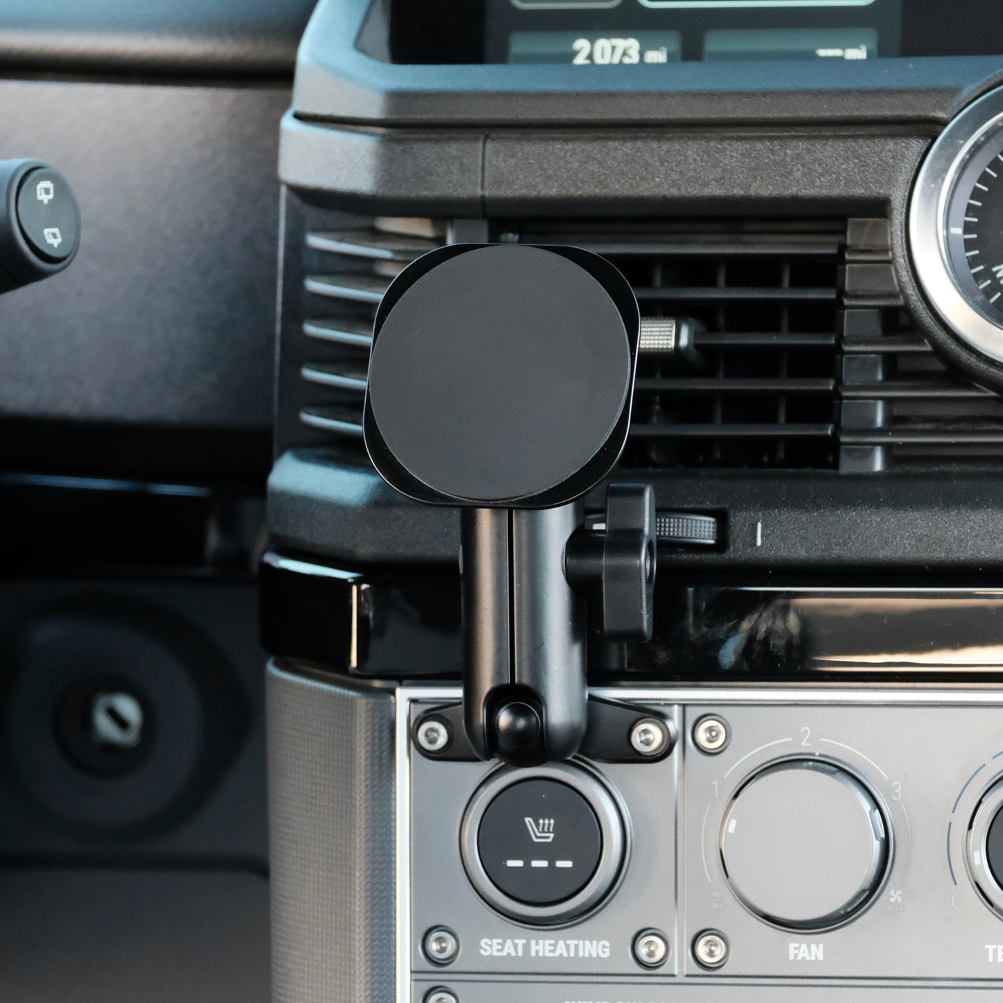 Image of Offroam MagSafe-compatible Phone Mount installed securely in INEOS Grenadier 2022-2025. This premium phone mount installs easily without drilling or glue. High force magnets hold phone on any trail, road, or track. Perfect placement without blocking screens, driver view, or air flow. Fully adjustable positioning.