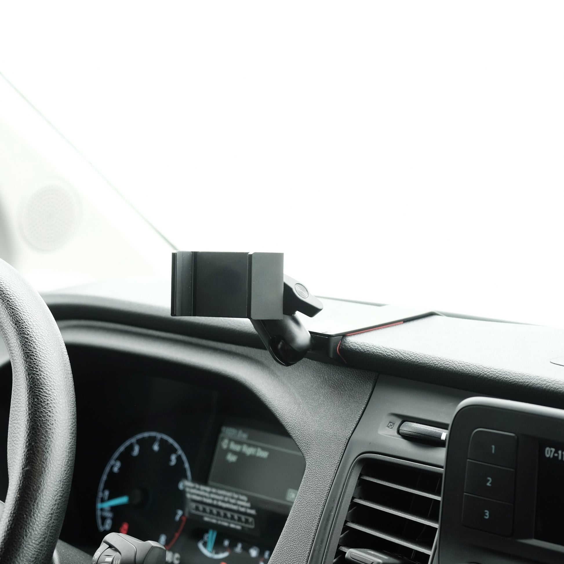 Image of Offroam Phone Mount installed securely in Ford Transit 2020-2025. This premium phone mount installs easily without drilling or glue. Spring loaded Universal holder for use with any phone. Perfect placement without blocking screens, driver view, or air flow. Fully adjustable positioning.