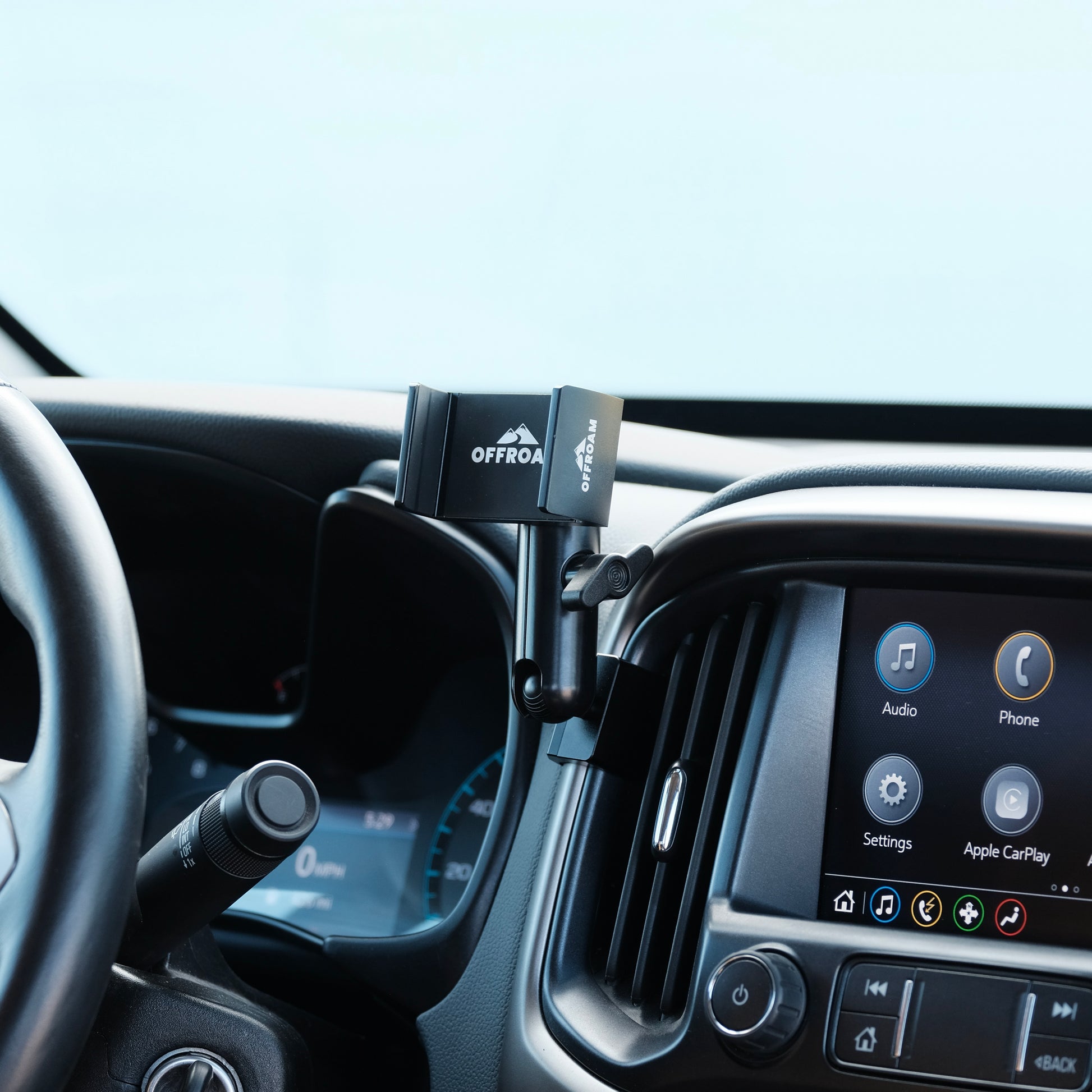 Image of Offroam Phone Mount installed securely in Chevy Colorado | GMC Canyon 2015-2022. This premium phone mount installs easily without drilling or glue. Spring loaded Universal holder for use with any phone. Perfect placement without blocking screens, driver view, or air flow. Fully adjustable positioning.