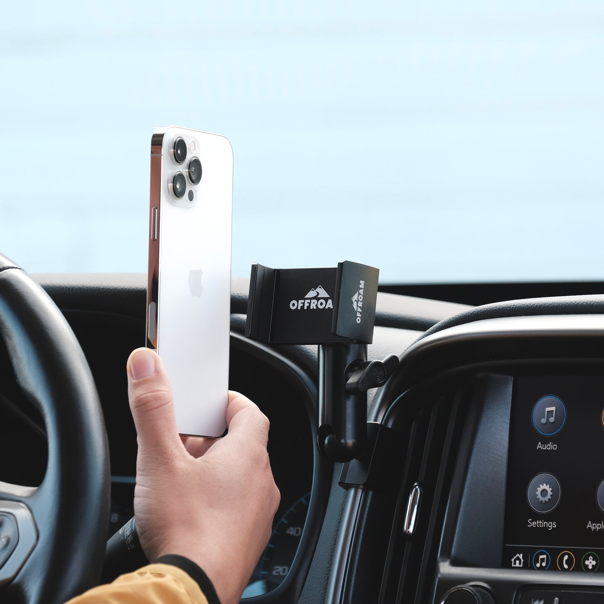 Image of Offroam Phone Mount installed securely in Chevy Colorado | GMC Canyon 2015-2022. This premium phone mount installs easily without drilling or glue. Spring loaded Universal holder for use with any phone. Perfect placement without blocking screens, driver view, or air flow. Fully adjustable positioning.