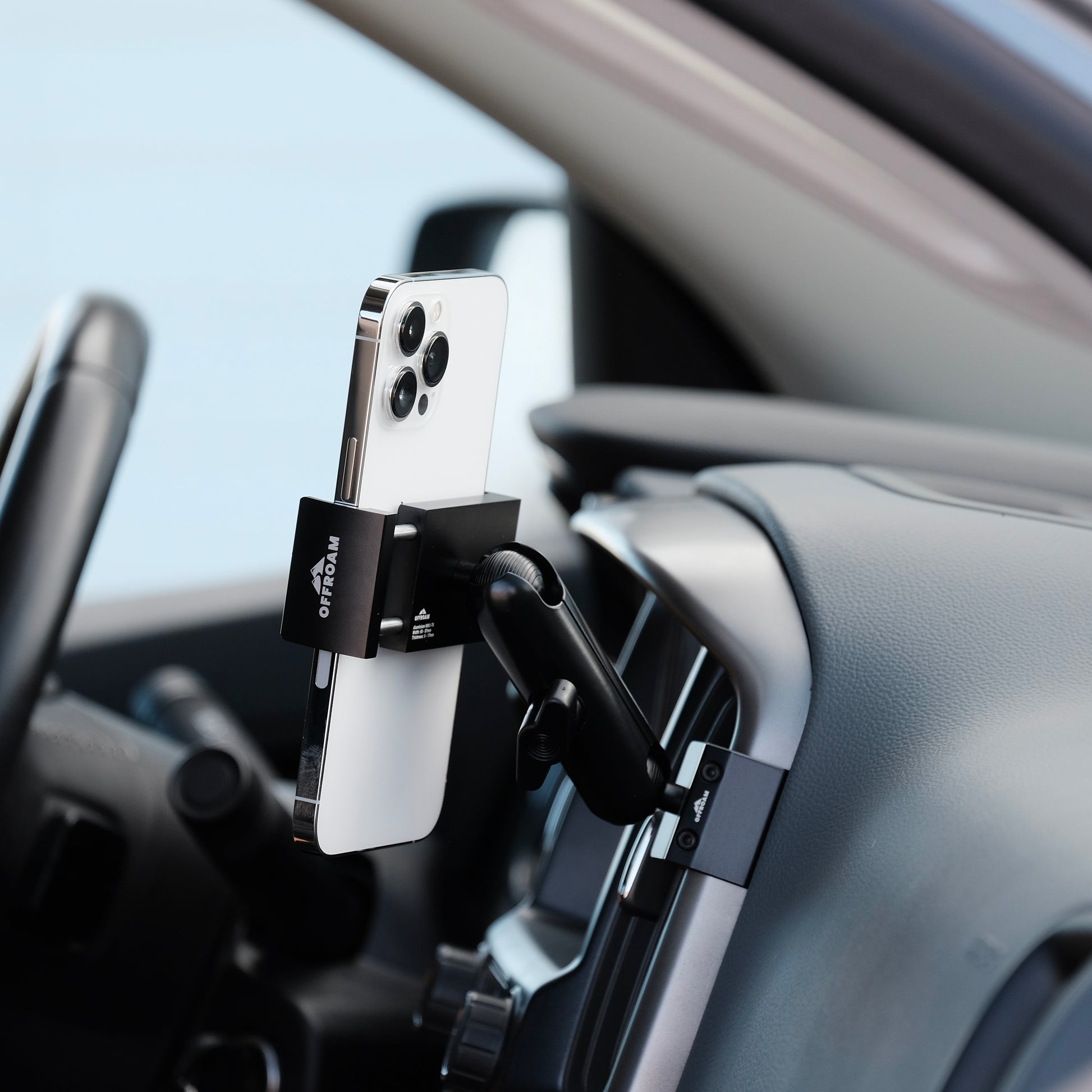 Image of Offroam Phone Mount installed securely in Chevy Colorado | GMC Canyon 2015-2022. This premium phone mount installs easily without drilling or glue. Spring loaded Universal holder for use with any phone. Perfect placement without blocking screens, driver view, or air flow. Fully adjustable positioning.
