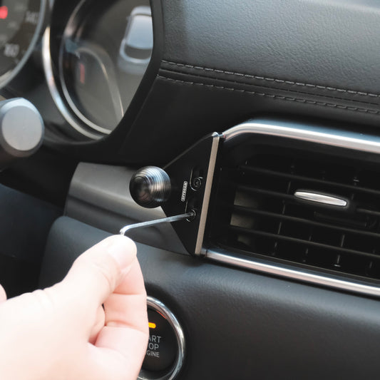 Image of Offroam Mounting Base installed securely in Mazda CX-5 2017-2025. This premium all metal phone mounting base installs easily without drilling or glue. Perfect placement without blocking screens, driver view, or air flow.