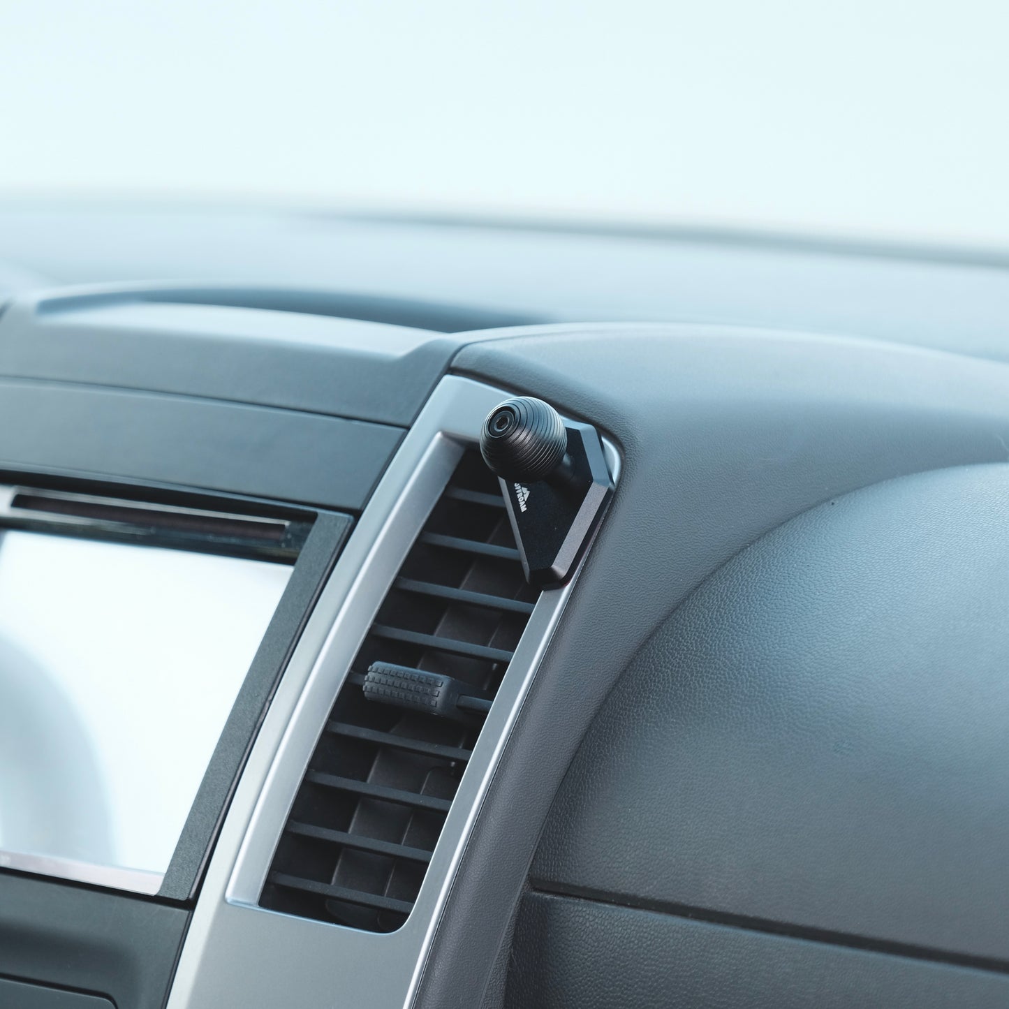 Image of Offroam Mounting Base installed securely in Nissan Frontier 2009-2021 | Xterra 2009-2015. This premium all metal phone mounting base installs easily without drilling or glue. Perfect placement without blocking screens, driver view, or air flow.