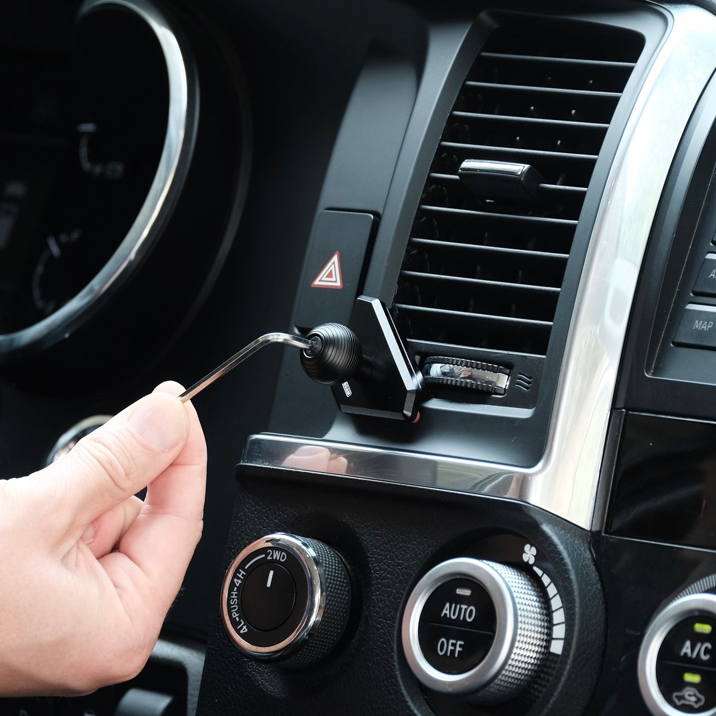 Image of Offroam Mounting Base installed securely in Toyota Tundra 2007-2013 | Sequoia 2008-2022. This premium all metal phone mounting base installs easily without drilling or glue. Perfect placement without blocking screens, driver view, or air flow.