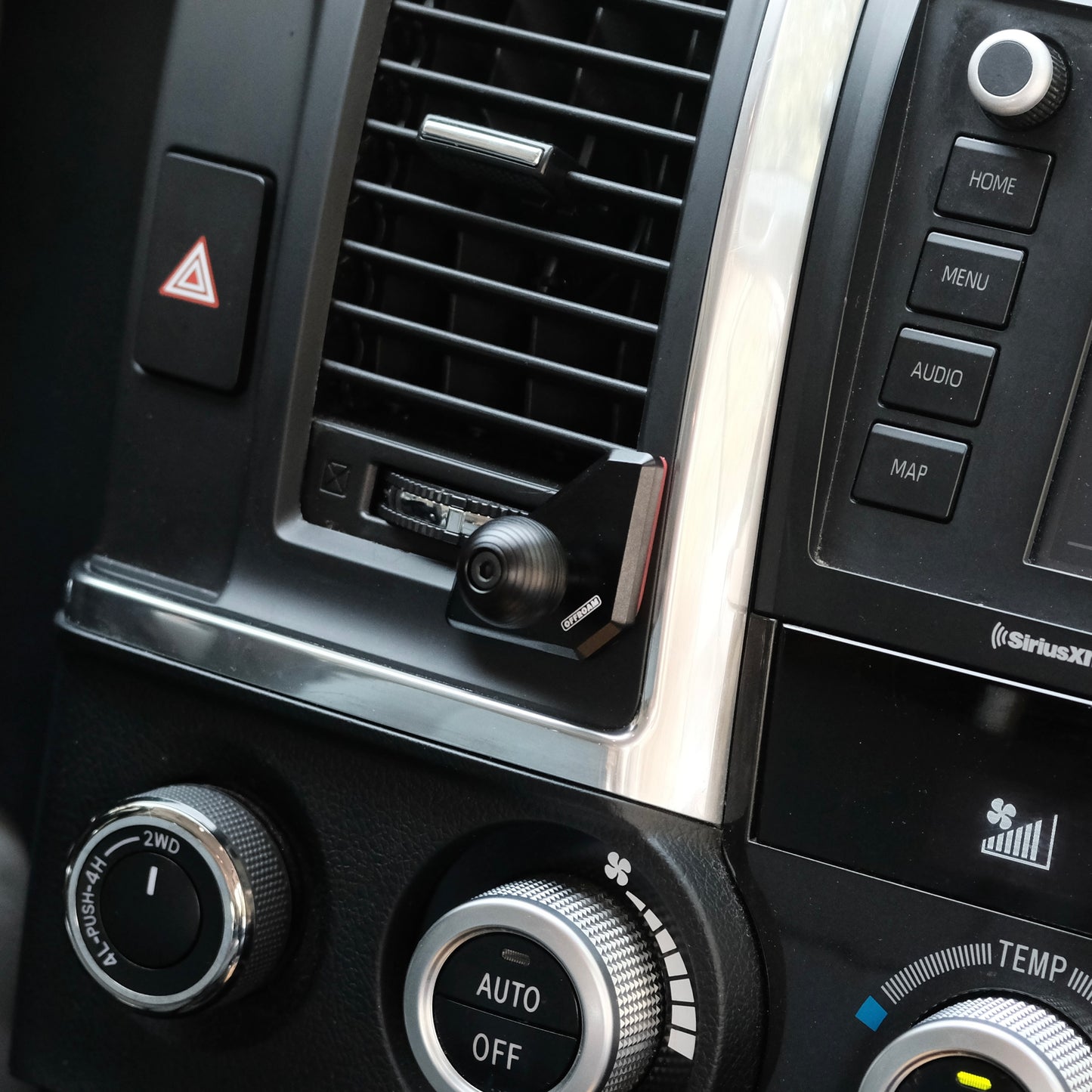 Image of Offroam Mounting Base installed securely in Toyota Tundra 2007-2013 | Sequoia 2008-2022. This premium all metal phone mounting base installs easily without drilling or glue. Perfect placement without blocking screens, driver view, or air flow.