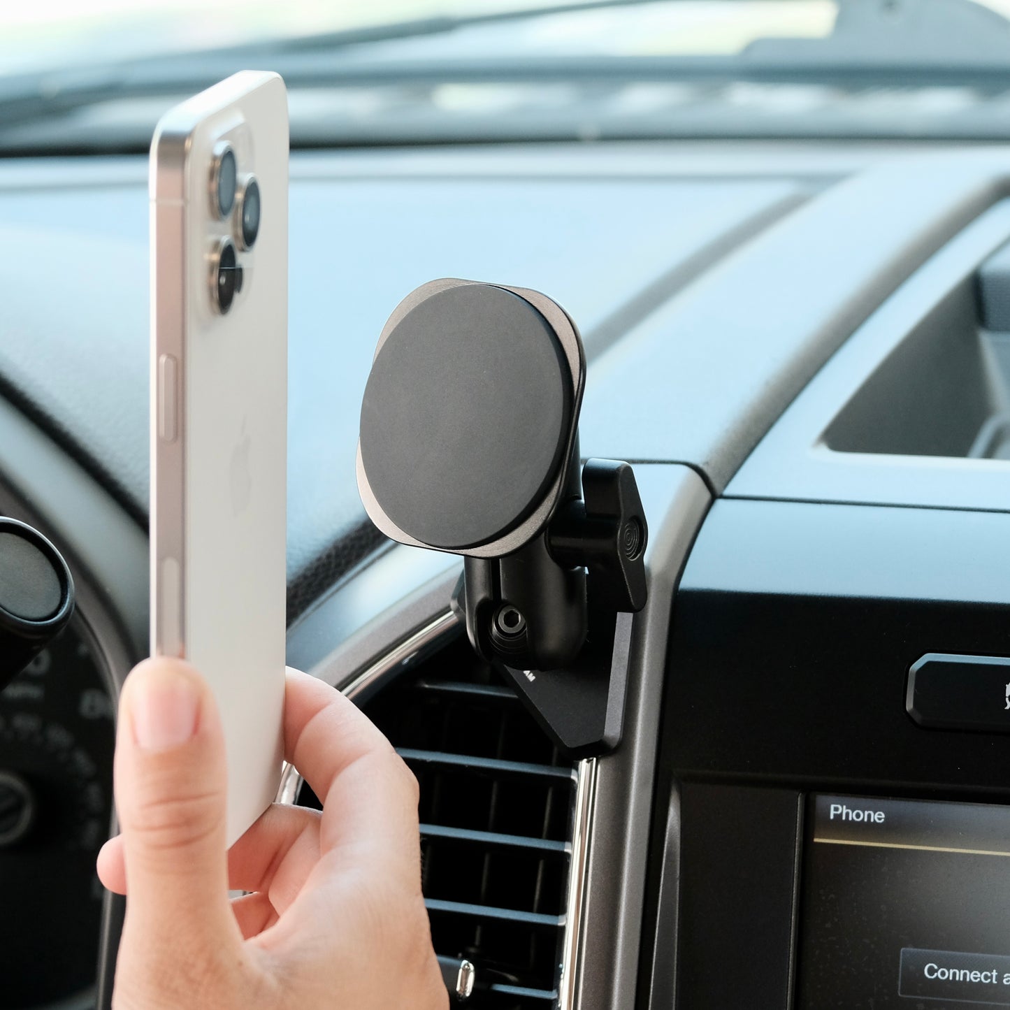 Image of Offroam MagSafe-compatible Phone Mount installed securely in Ford F-150 2015-2020 | Super Duty 2017-2021 & 2022 (XL and XLT) | Expedition 2018-2021. This premium phone mount installs easily without drilling or glue. High force magnets hold phone on any trail, road, or track. Perfect placement without blocking screens, driver view, or air flow. Fully adjustable positioning.