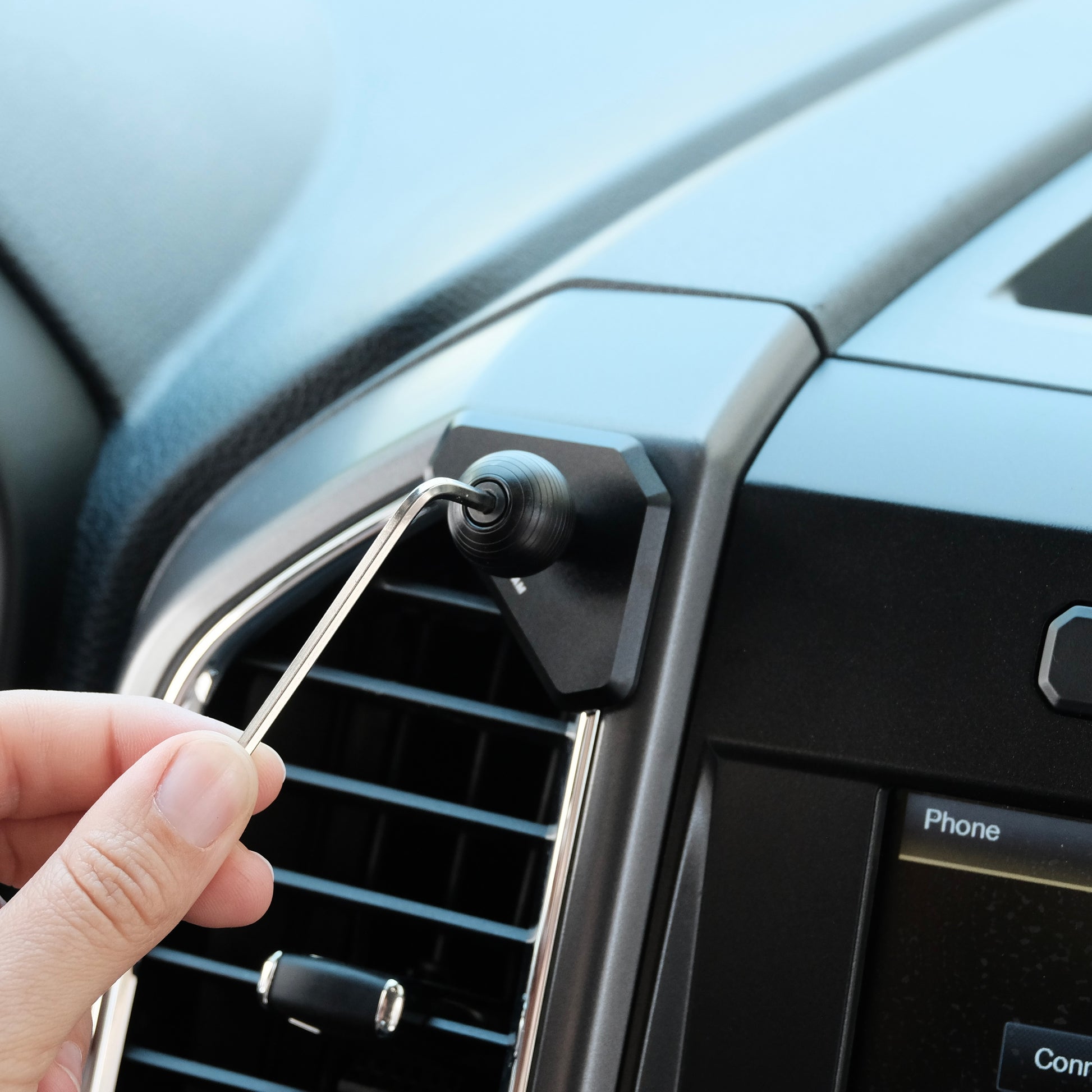 Image of Offroam Mounting Base installed securely in Ford F-150 2015-2020 | Super Duty 2017-2021 & 2022 (XL and XLT) | Expedition 2018-2021. This premium all metal phone mounting base installs easily without drilling or glue. Perfect placement without blocking screens, driver view, or air flow.