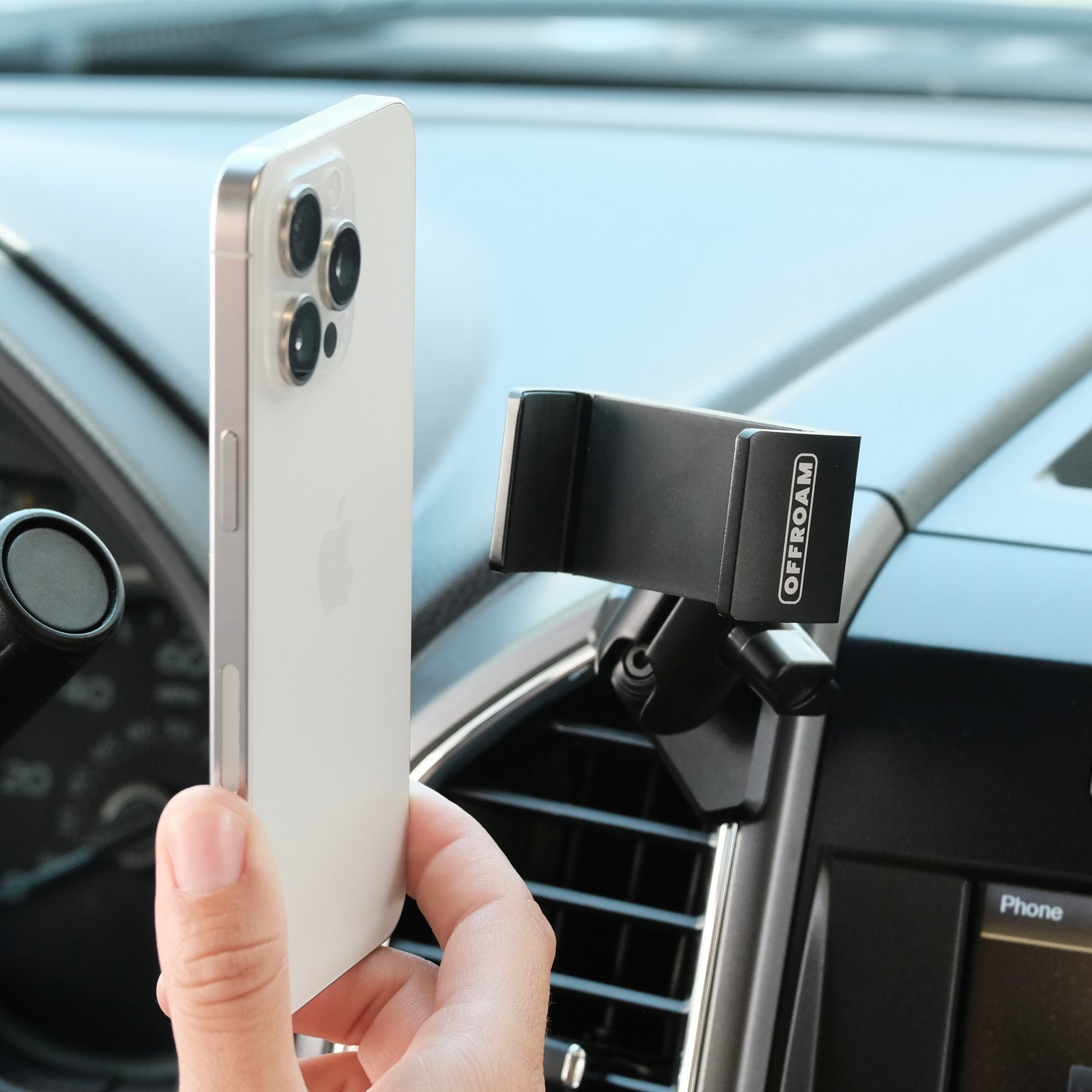 Image of Offroam Phone Mount installed securely in Ford F-150 2015-2020 | Super Duty 2017-2021 & 2022 (XL and XLT) | Expedition 2018-2021. This premium phone mount installs easily without drilling or glue. Spring loaded Universal holder for use with any phone. Perfect placement without blocking screens, driver view, or air flow. Fully adjustable positioning.