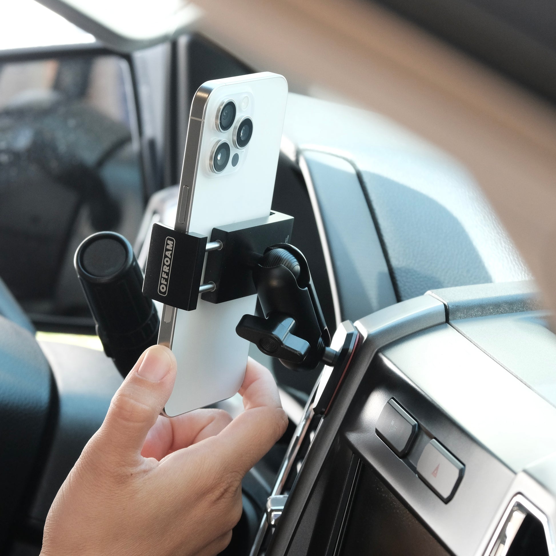 Image of Offroam Phone Mount installed securely in Ford F-150 2015-2020 | Super Duty 2017-2021 & 2022 (XL and XLT) | Expedition 2018-2021. This premium phone mount installs easily without drilling or glue. Spring loaded Universal holder for use with any phone. Perfect placement without blocking screens, driver view, or air flow. Fully adjustable positioning.