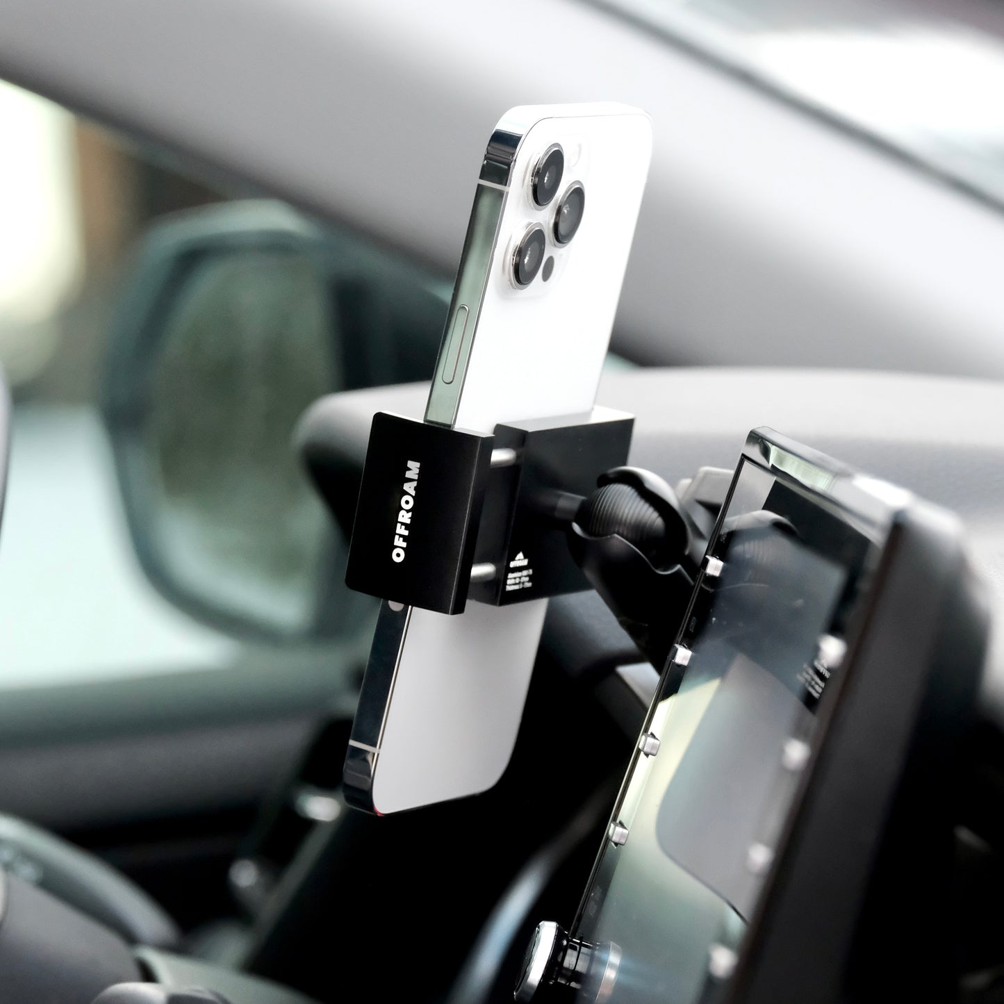 Image of Offroam Phone Mount installed securely in Toyota Camry 2021-2024. This premium phone mount installs easily without drilling or glue. Spring loaded Universal holder for use with any phone. Perfect placement without blocking screens, driver view, or air flow. Fully adjustable positioning.