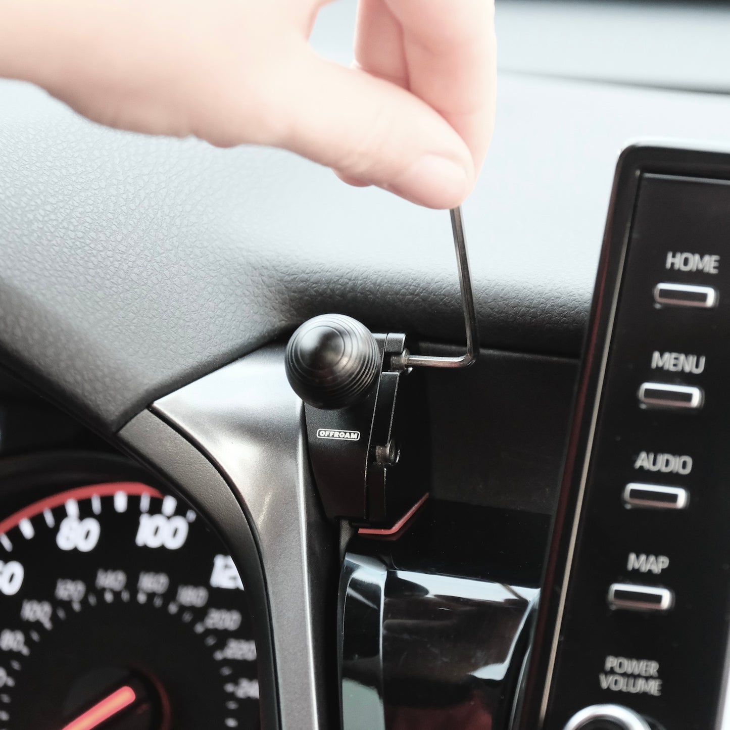 Image of Offroam Mounting Base installed securely in Toyota Camry 2021-2024. This premium all metal phone mounting base installs easily without drilling or glue. Perfect placement without blocking screens, driver view, or air flow.
