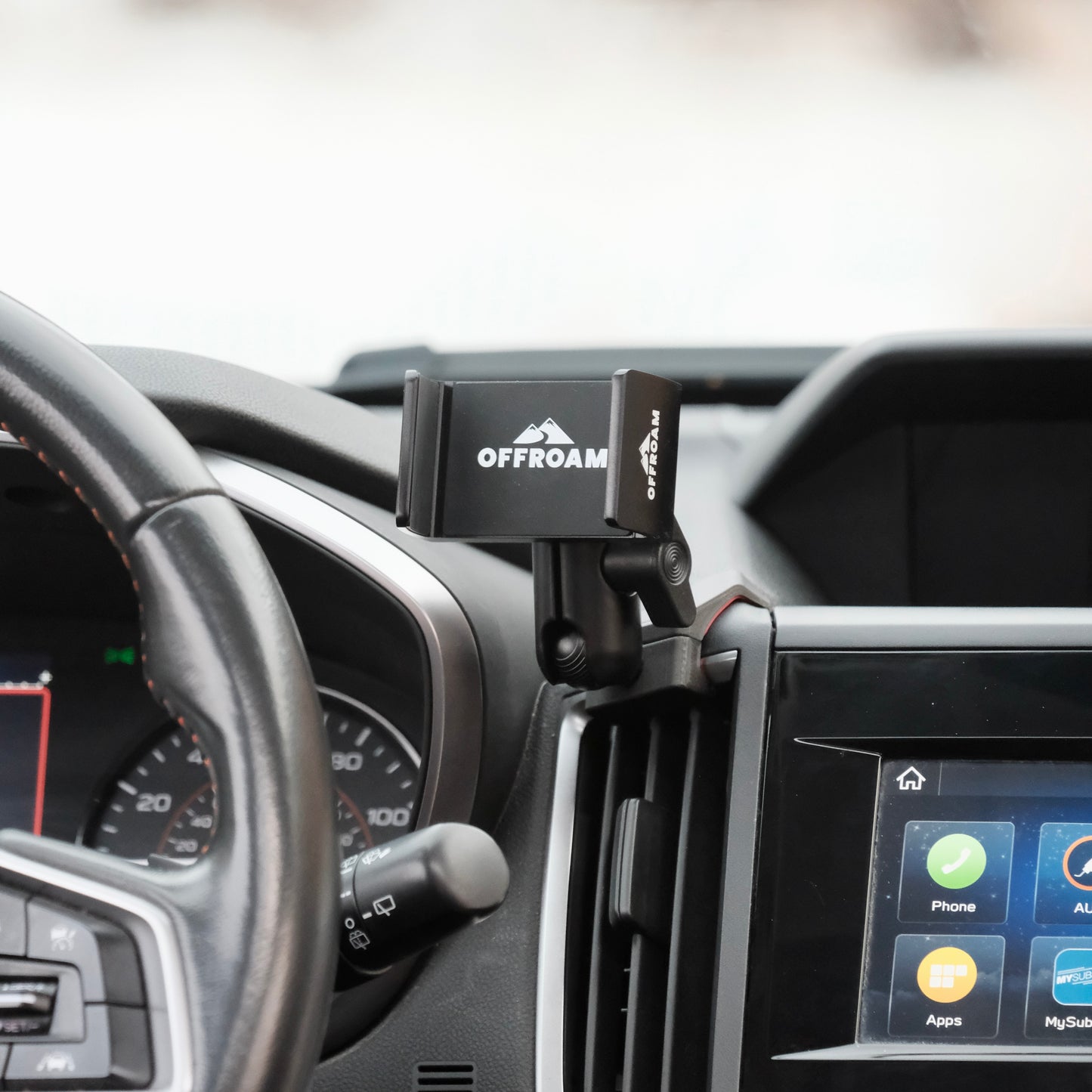 Image of Offroam Phone Mount installed securely in Subaru Crosstrek 2018-2023 | Forester 2019-2024| Impreza 2017-2023. This premium phone mount installs easily without drilling or glue. Spring loaded Universal holder for use with any phone. Perfect placement without blocking screens, driver view, or air flow. Fully adjustable positioning.
