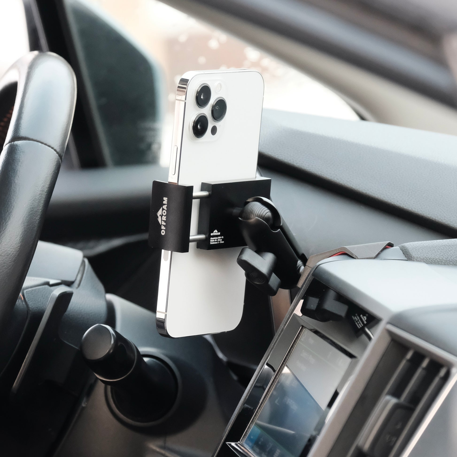 Image of Offroam Phone Mount installed securely in Subaru Crosstrek 2018-2023 | Forester 2019-2024| Impreza 2017-2023. This premium phone mount installs easily without drilling or glue. Spring loaded Universal holder for use with any phone. Perfect placement without blocking screens, driver view, or air flow. Fully adjustable positioning.