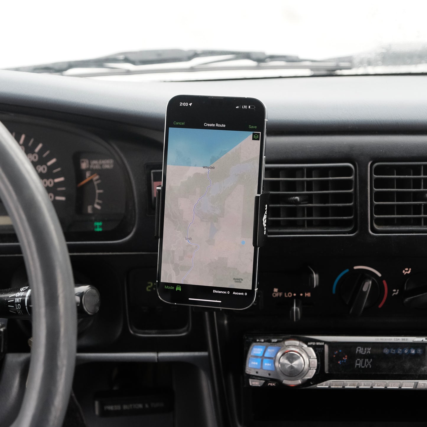 Image of Offroam Phone Mount installed securely in Toyota Tacoma 1996-2004. This premium phone mount installs easily without drilling or glue. Spring loaded Universal holder for use with any phone. Perfect placement without blocking screens, driver view, or air flow. Fully adjustable positioning.