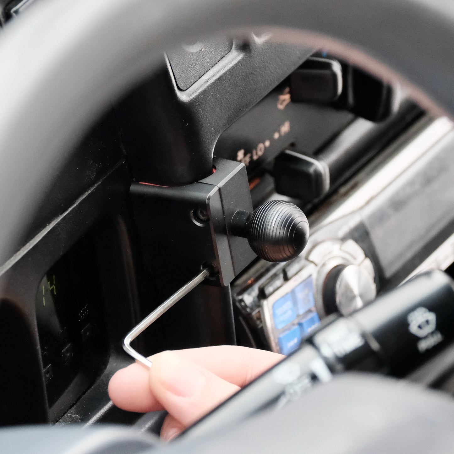 Image of Offroam Mounting Base installed securely in Toyota Tacoma 1996-2004. This premium all metal phone mounting base installs easily without drilling or glue. Perfect placement without blocking screens, driver view, or air flow.