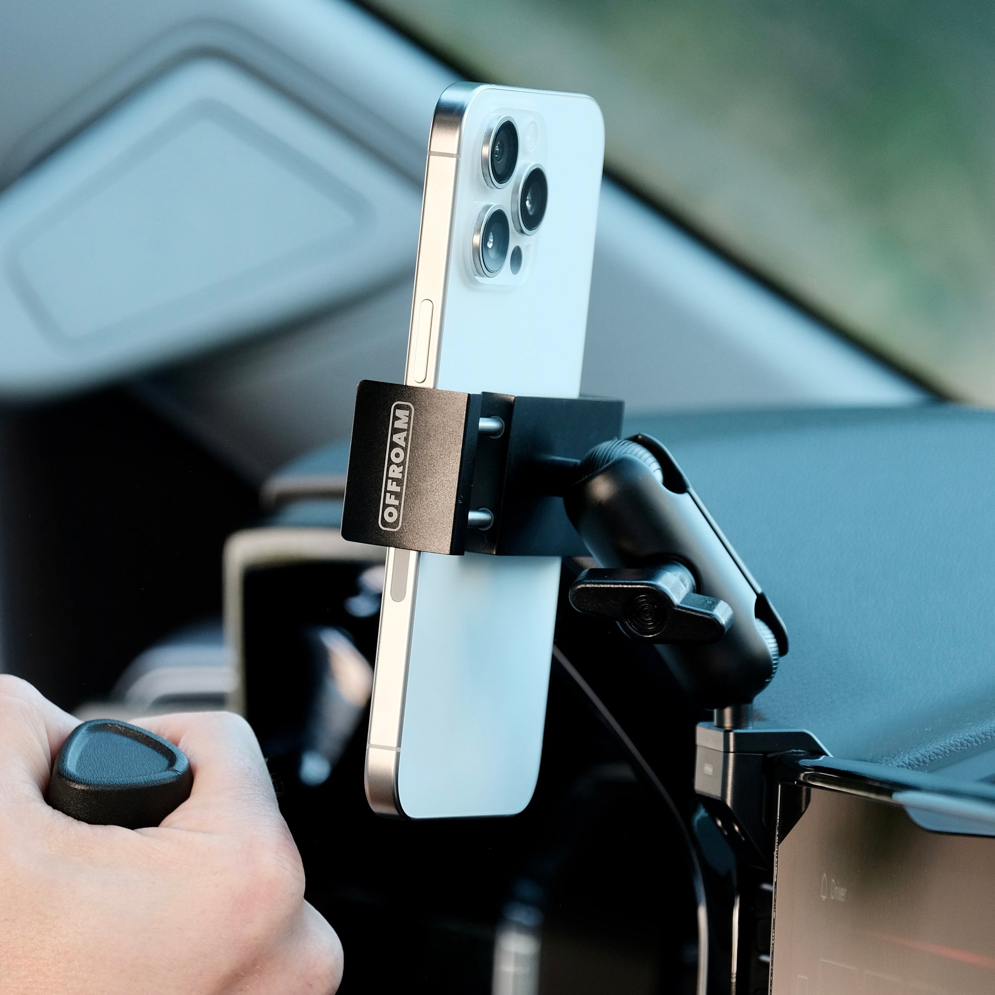 Image of Offroam Phone Mount installed securely in Chevrolet Silverado 2022-2025 | Silverado HD 2024-2025 and GMC Sierra 1500 2022-2025 | Sierra HD 2024-2025 with 13.4-in. display. This premium phone mount installs easily without drilling or glue. Spring loaded Universal holder for use with any phone. Perfect placement without blocking screens, driver view, or air flow. Fully adjustable positioning.